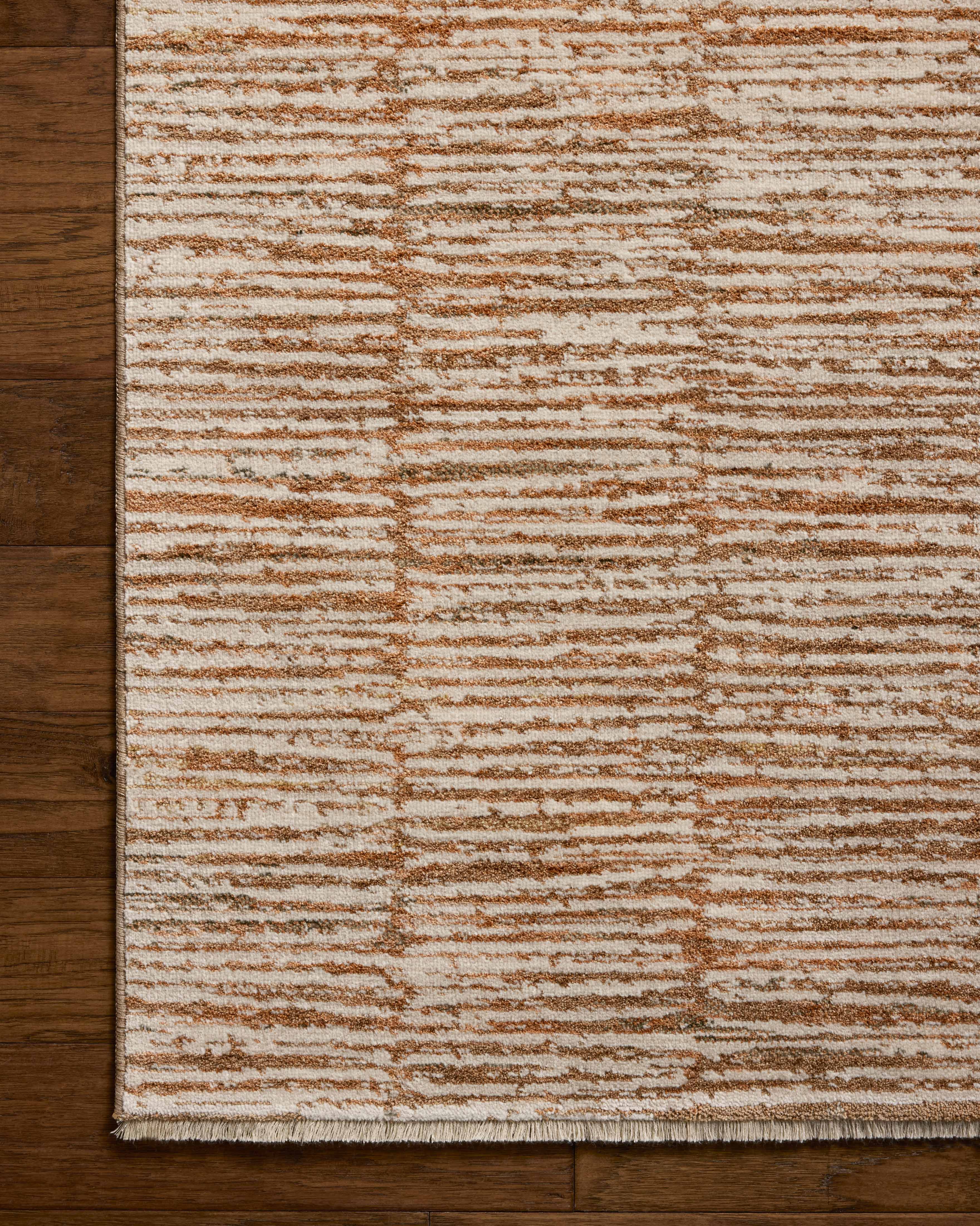 Featuring rich terracotta and refined ivory hues and graphic detail, the Nellie NEL-01 Terracotta / Ivory Area Rug is a power-loomed polyester and polypropylene area rug for any room
