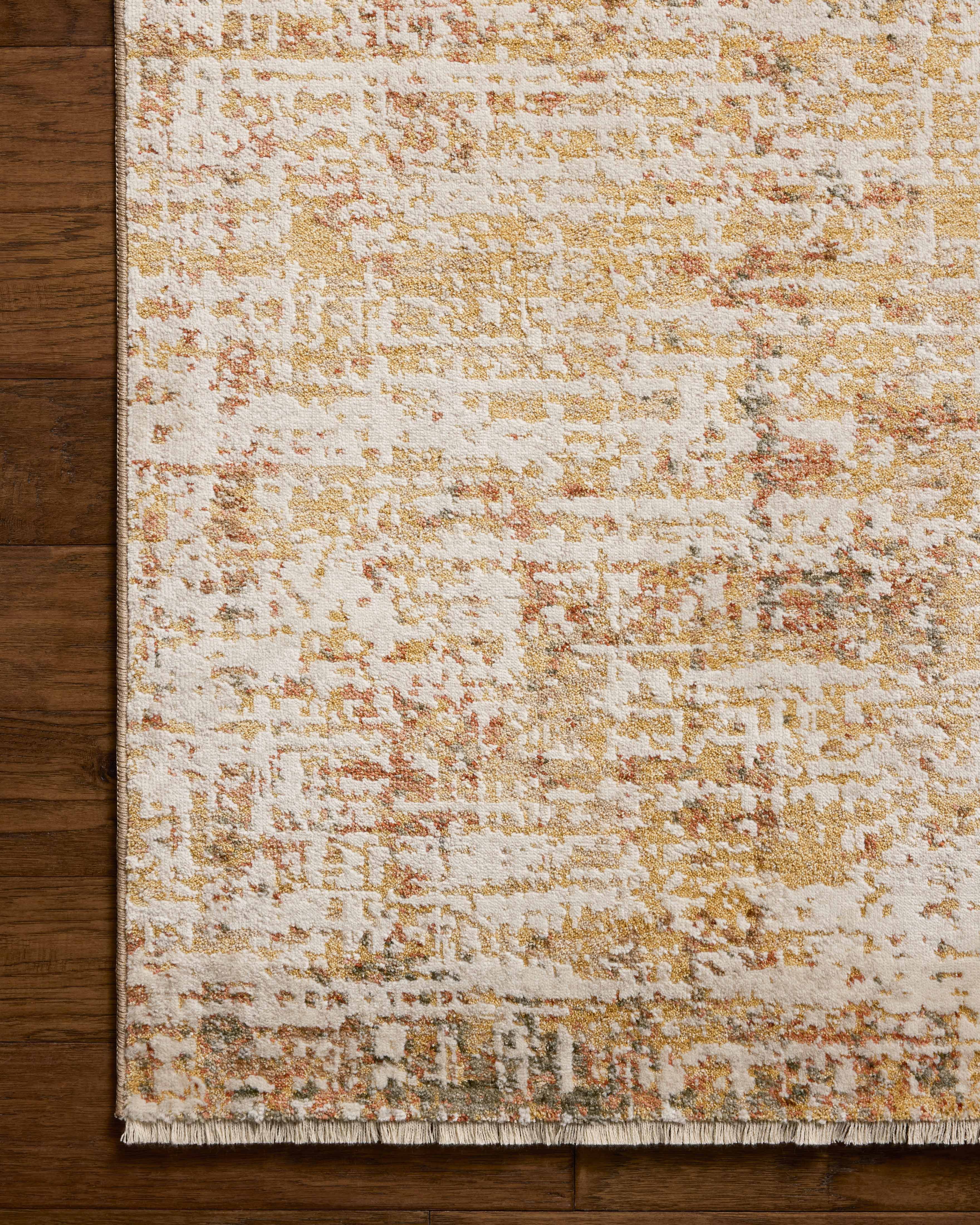 The Nellie NEL-02 Sunset / Pebble Area Rug pairs glowing sunset and subtle pebble tones and graphic patterns in a power-loomed polyester and polypropylene area rug