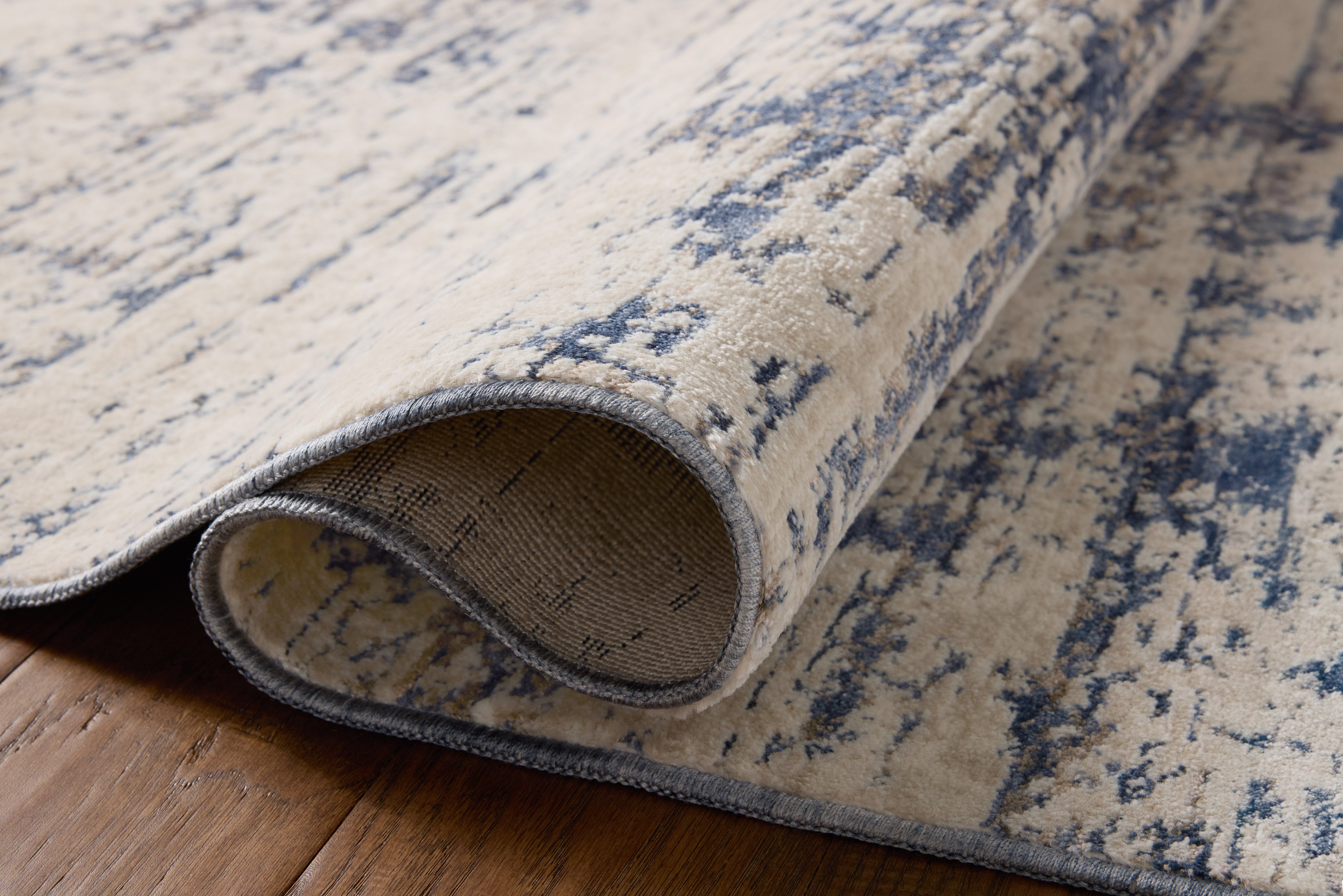 The Nellie NEL-05 Dove / Blue Area Rug delivers gentle dove and calming blue beauty and graphic elegance in a power-loomed polyester and polypropylene area rug