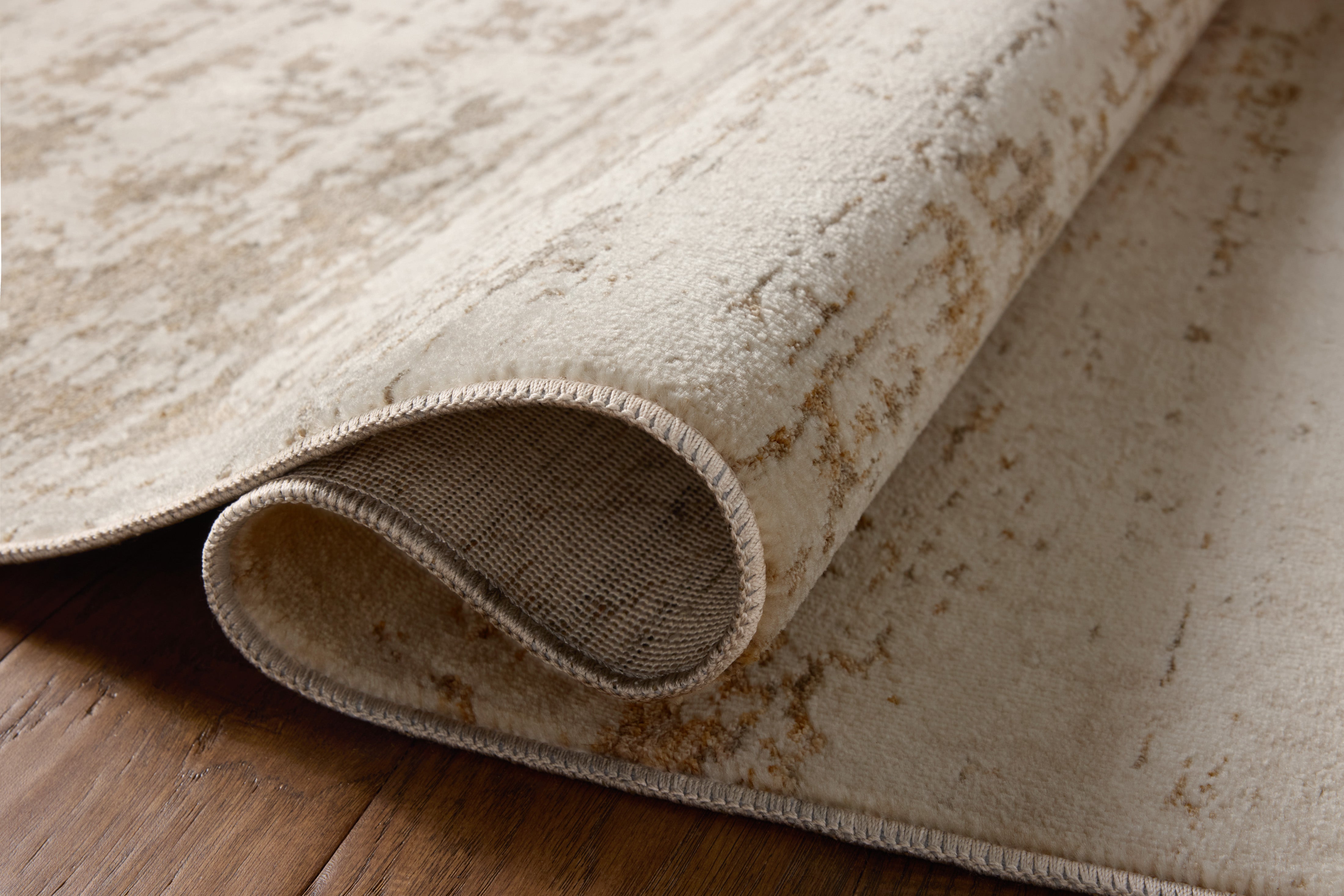 Designed with graphic artistry in gentle dove and warm natural hues, the Nellie NEL-05 Dove / Natural Area Rug is a power-loomed polyester and polypropylene area rug that stands out