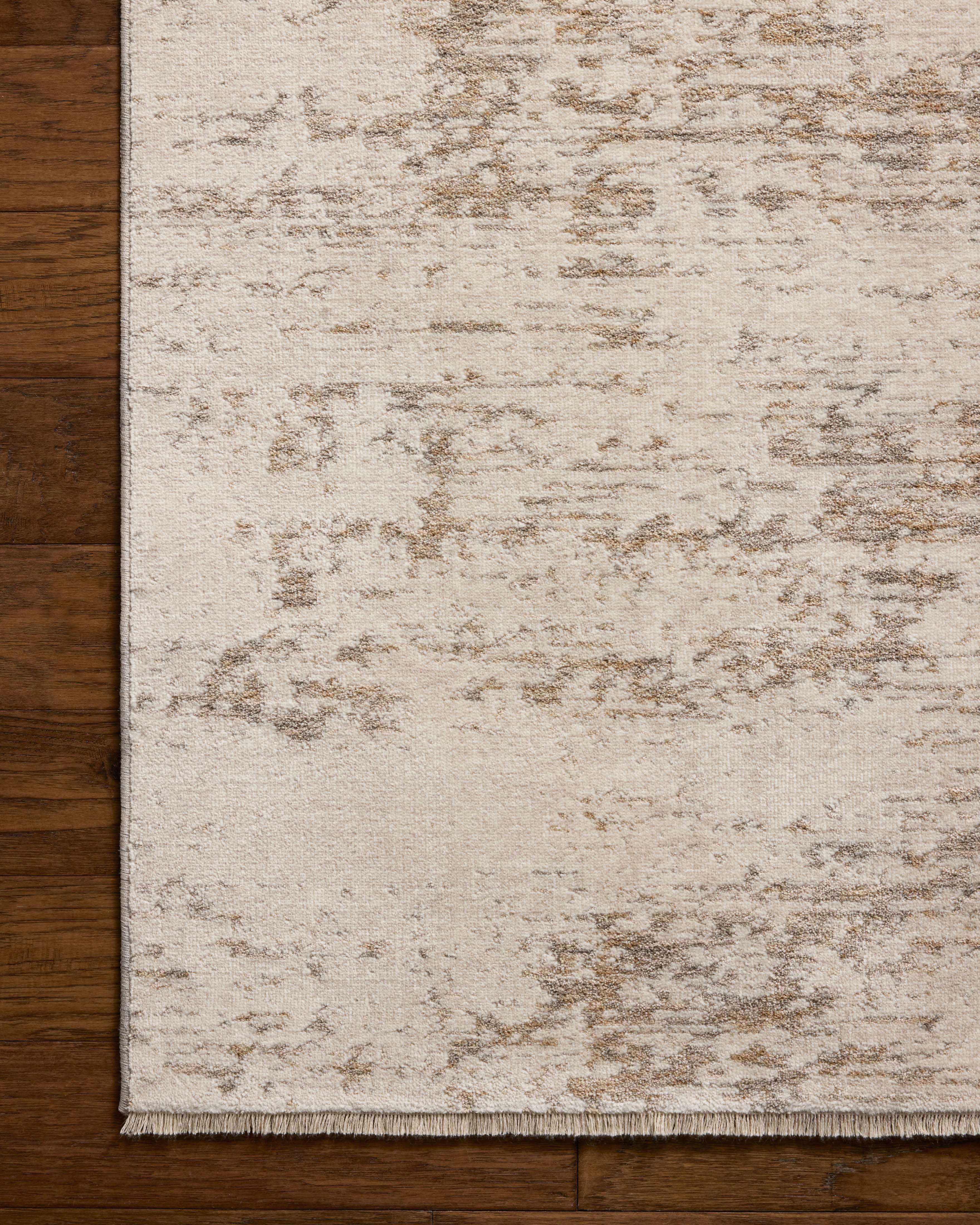 Designed with graphic artistry in gentle dove and warm natural hues, the Nellie NEL-05 Dove / Natural Area Rug is a power-loomed polyester and polypropylene area rug that stands out