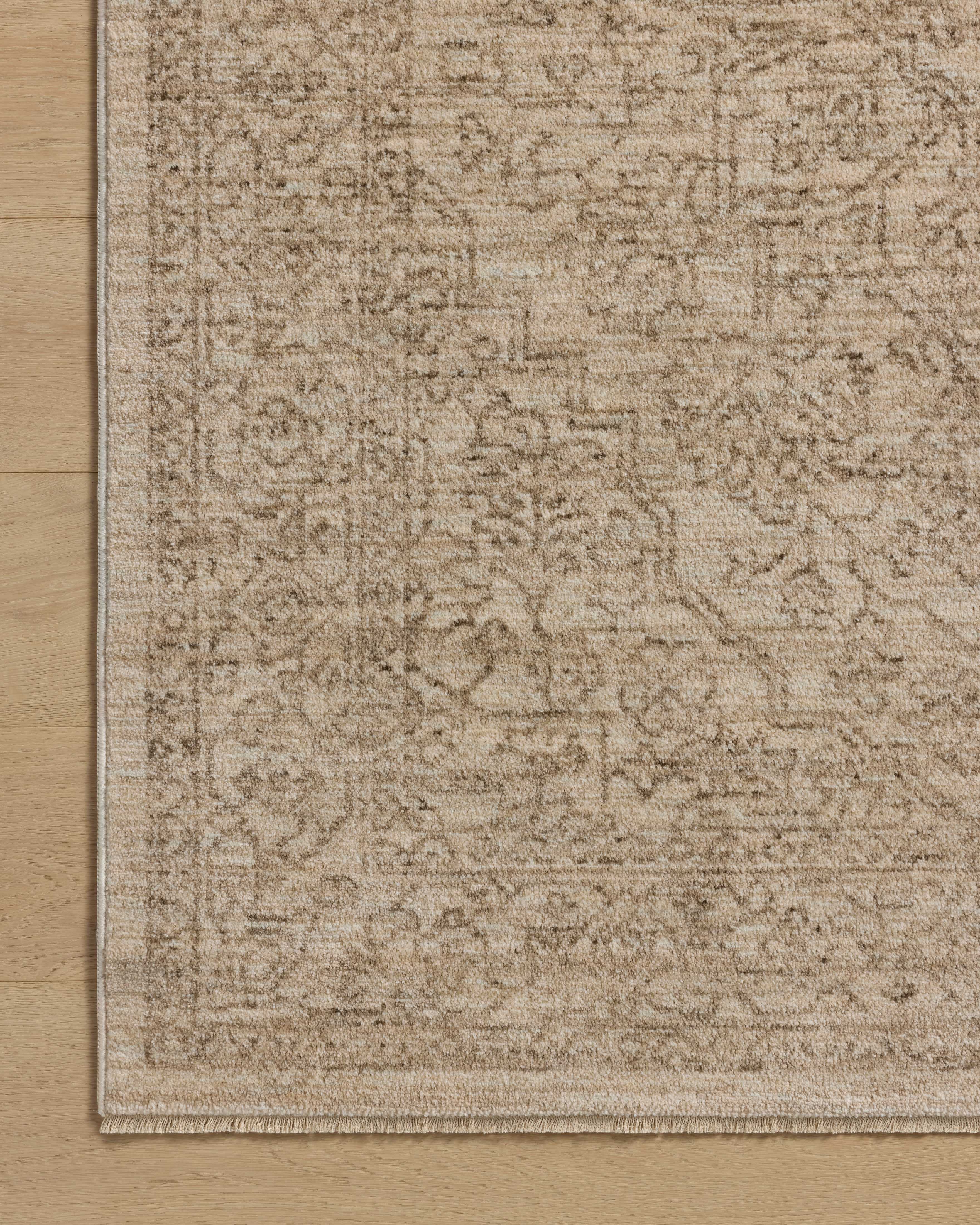 The Newman NEW-01 Taupe / Bone Area Rug transforms any space with versatile taupe and bone tones and vintage and distressed design in a power-loomed polyester area rug