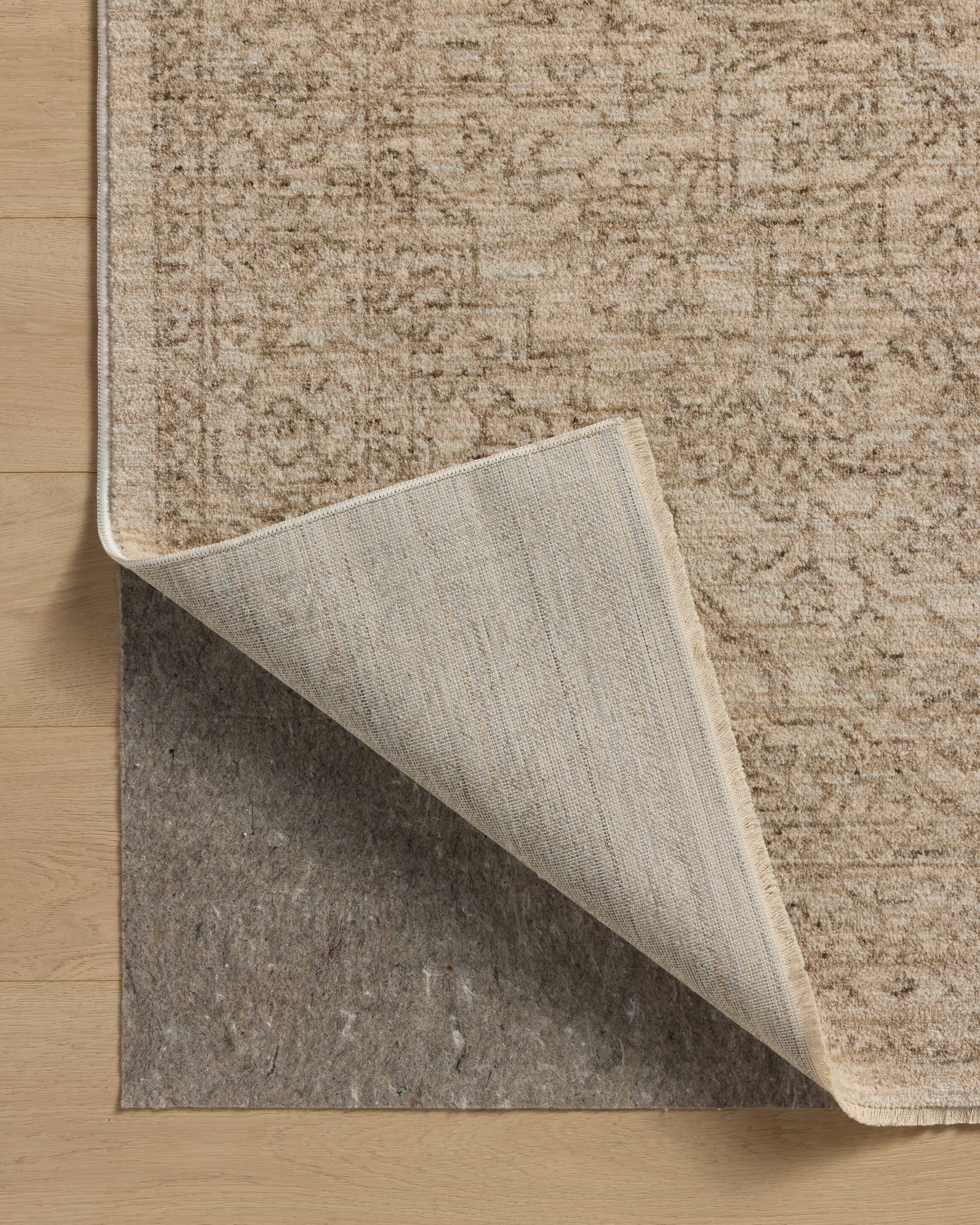 The Newman NEW-01 Taupe / Bone Area Rug transforms any space with versatile taupe and bone tones and vintage and distressed design in a power-loomed polyester area rug