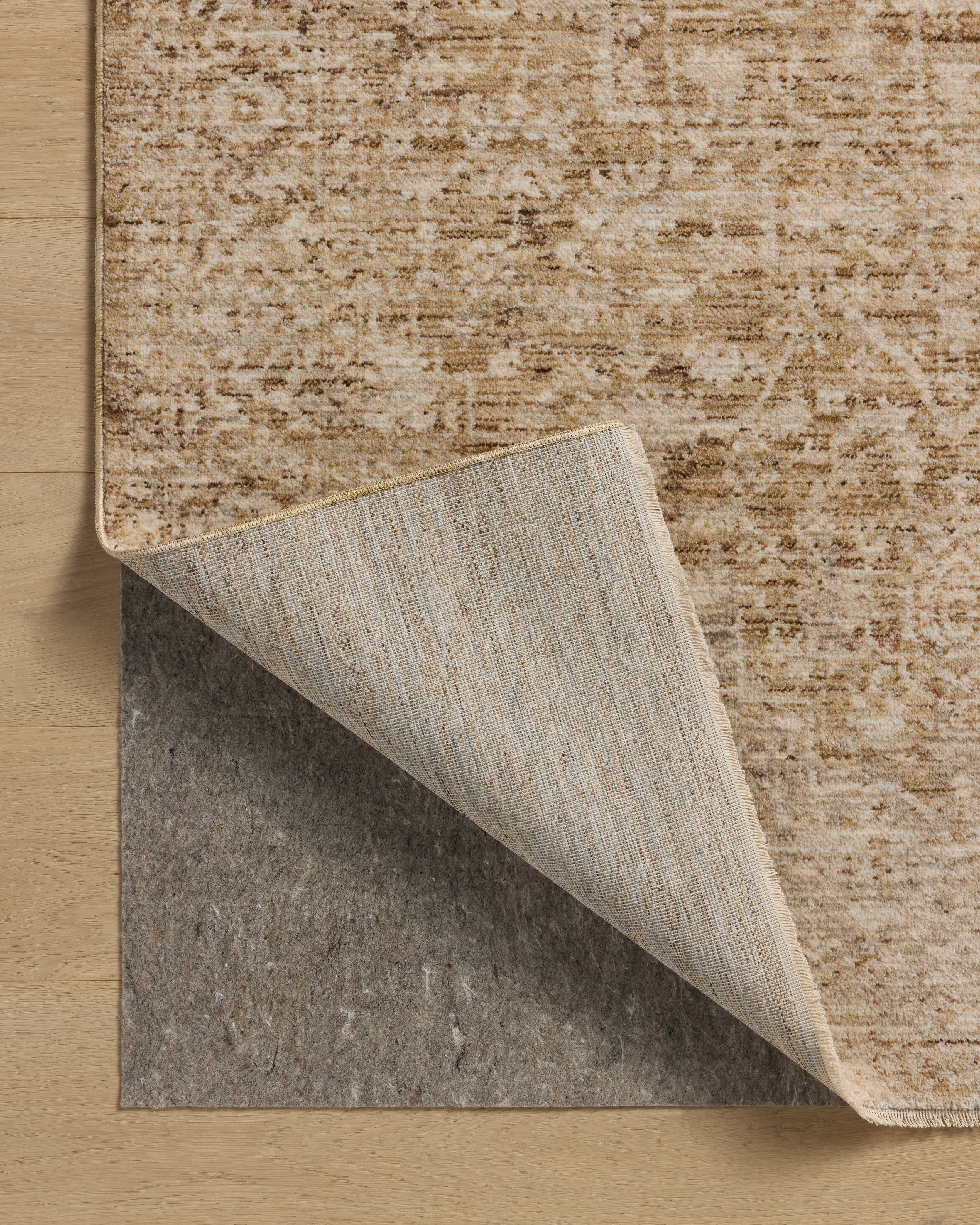 Layered in golden wheat and warm natural hues with vintage and distressed patterns, the Newman NEW-02 Wheat / Natural Area Rug is a power-loomed polyester area rug perfect for any setting