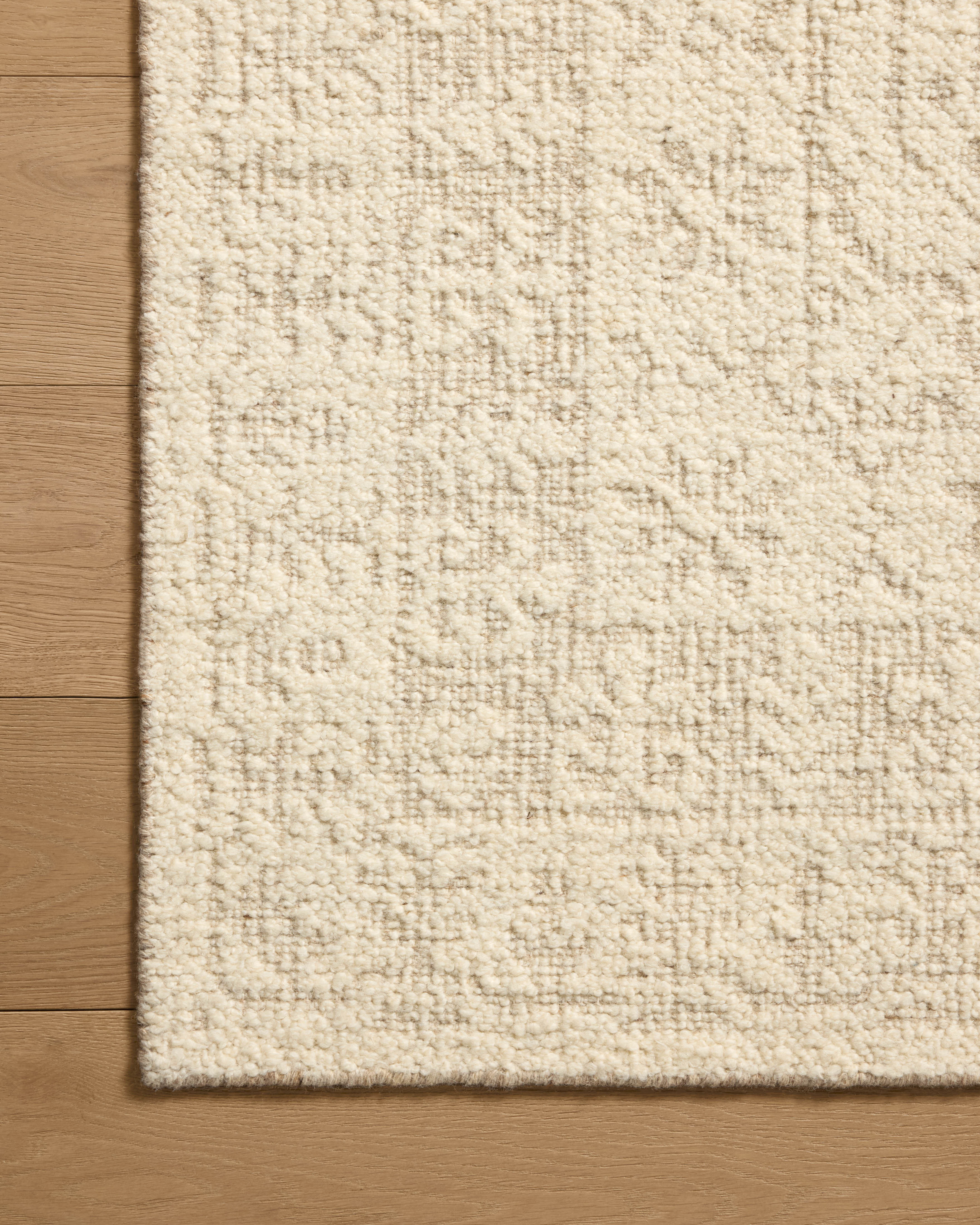 A hand-woven wool area rug featuring traditional design and refined ivory and gentle dove tones, the Novi NVI-01 Ivory / Dove Area Rug adds character to any room