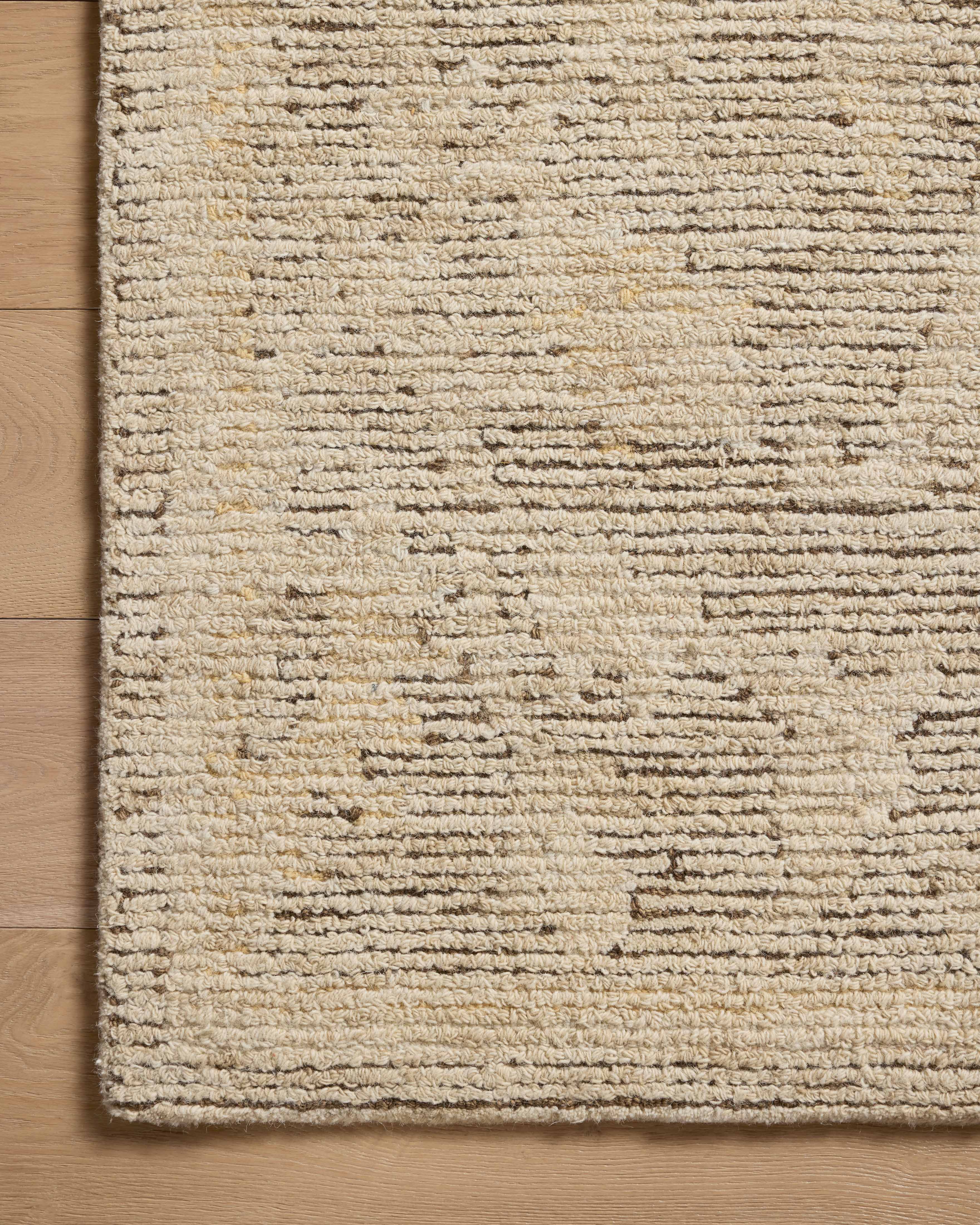 Layered in coffee and warm natural hues with ribbed and high-low textured patterns, the Penny PEN-02 Coffee / Natural Area Rug is a hand-tufted wool area rug perfect for any setting