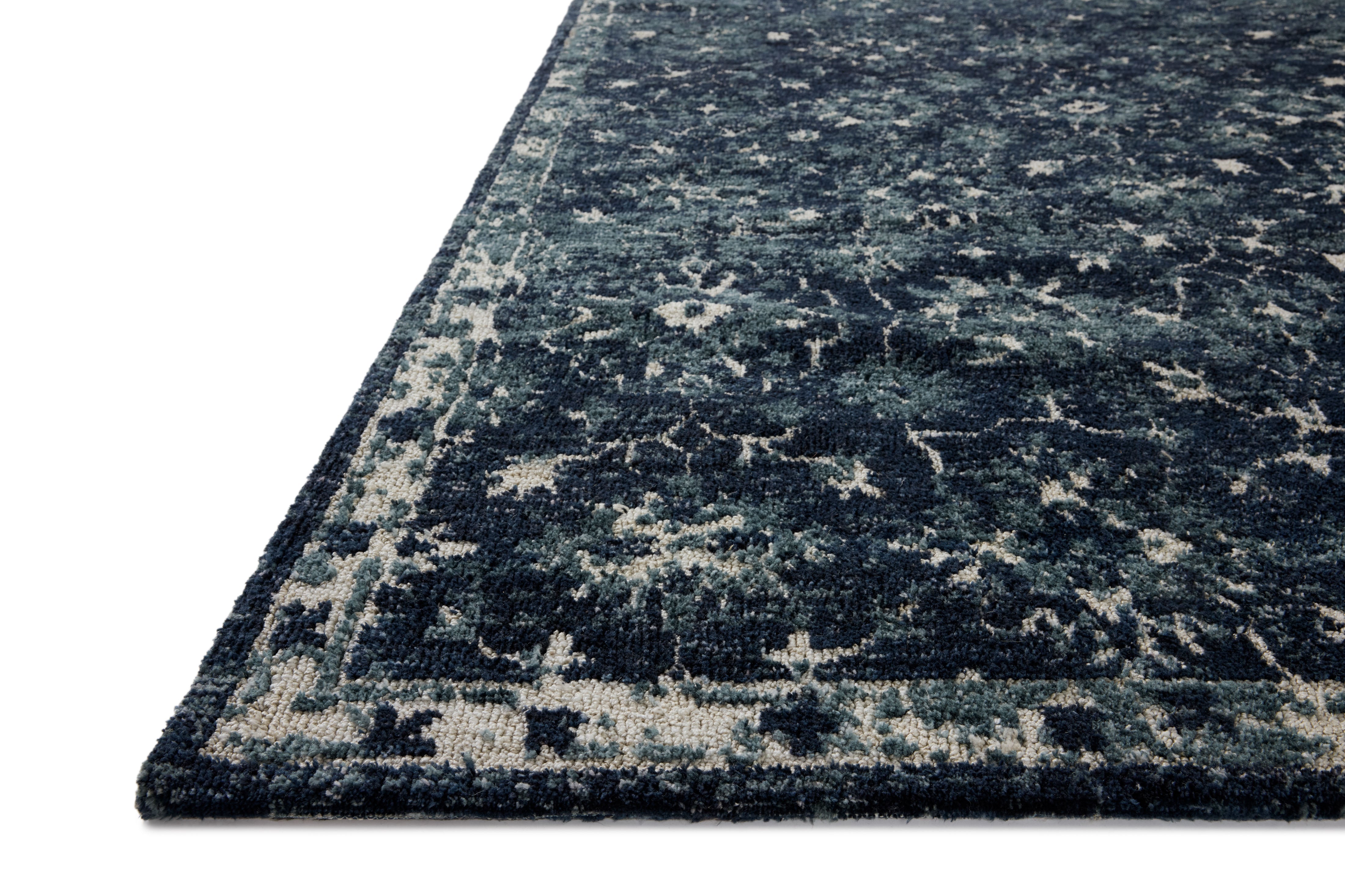 Dressed in classic navy and refined ivory hues with traditional detail, the Percival PCV-02 Navy / Ivory Area Rug is a power-loomed polyester area rug that completes any room
