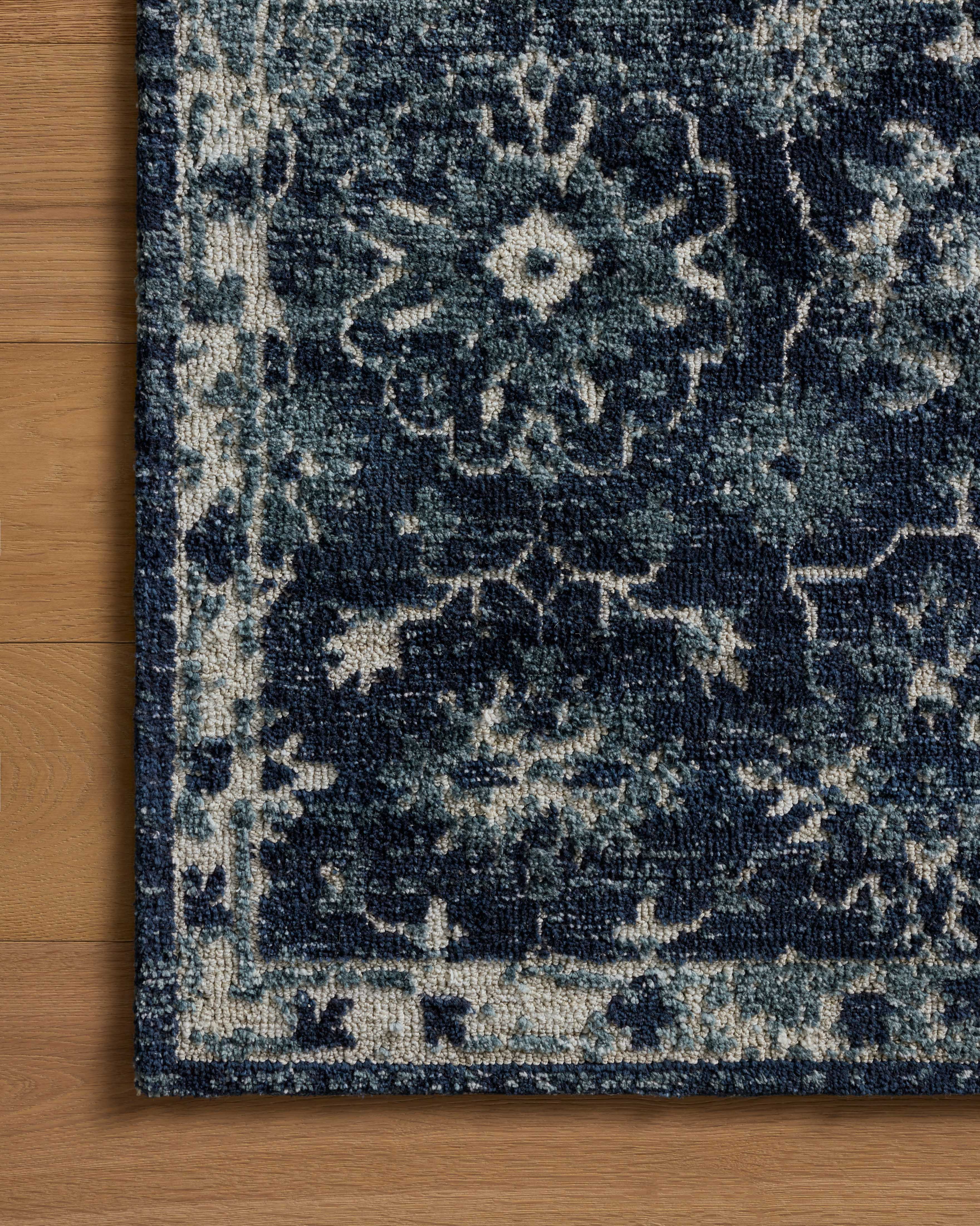 Dressed in classic navy and refined ivory hues with traditional detail, the Percival PCV-02 Navy / Ivory Area Rug is a power-loomed polyester area rug that completes any room