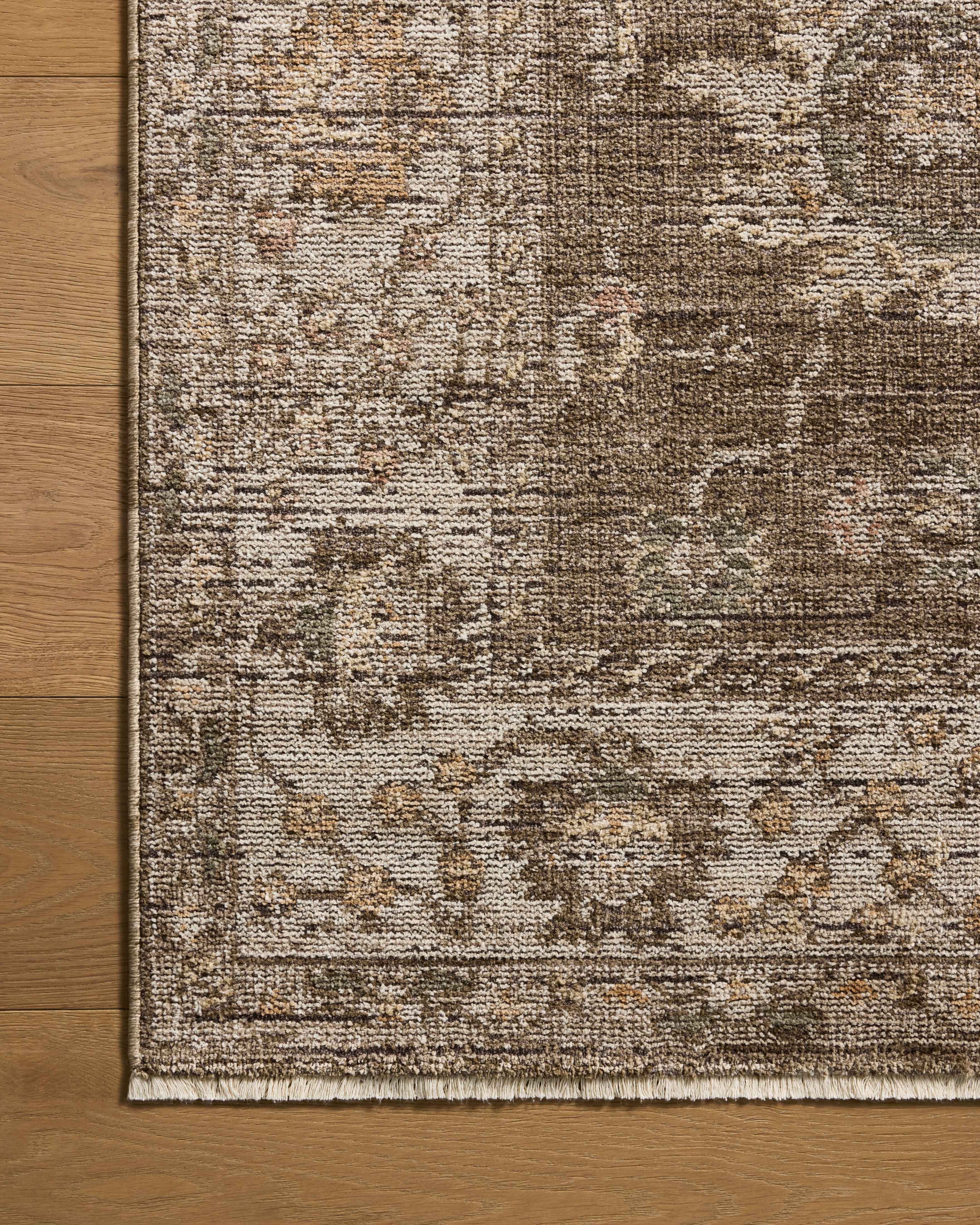 Layered in grounded bark and refined ivory hues with vintage patterns, the Priscilla PRL-01 Bark / Ivory Area Rug is a power-loomed 100% polyester area rug perfect for any setting