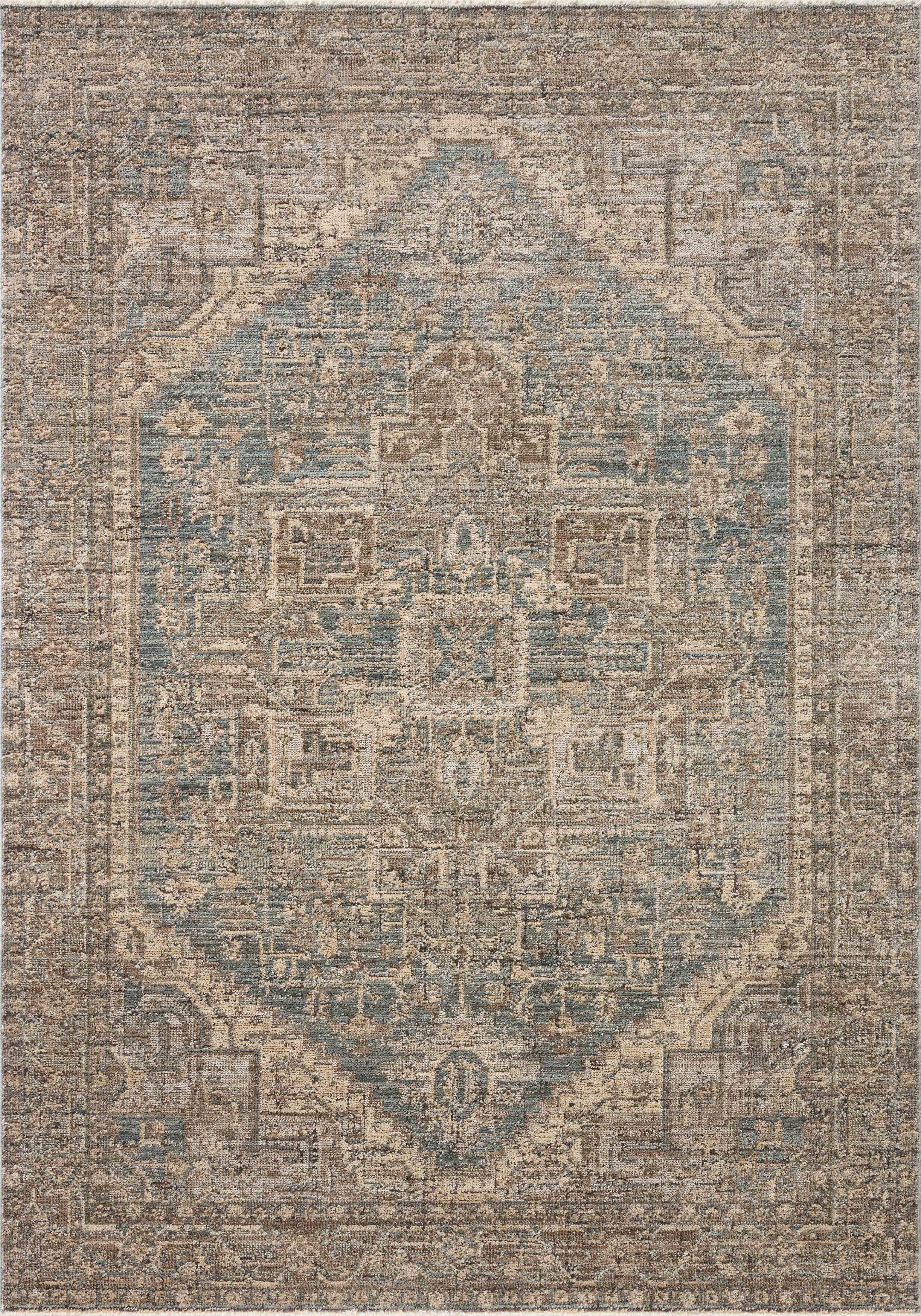 A power-loomed 100% polyester area rug with vintage flair in calming blue and grounded bark tones, the Priscilla PRL-04 Blue / Bark Area Rug anchors any room