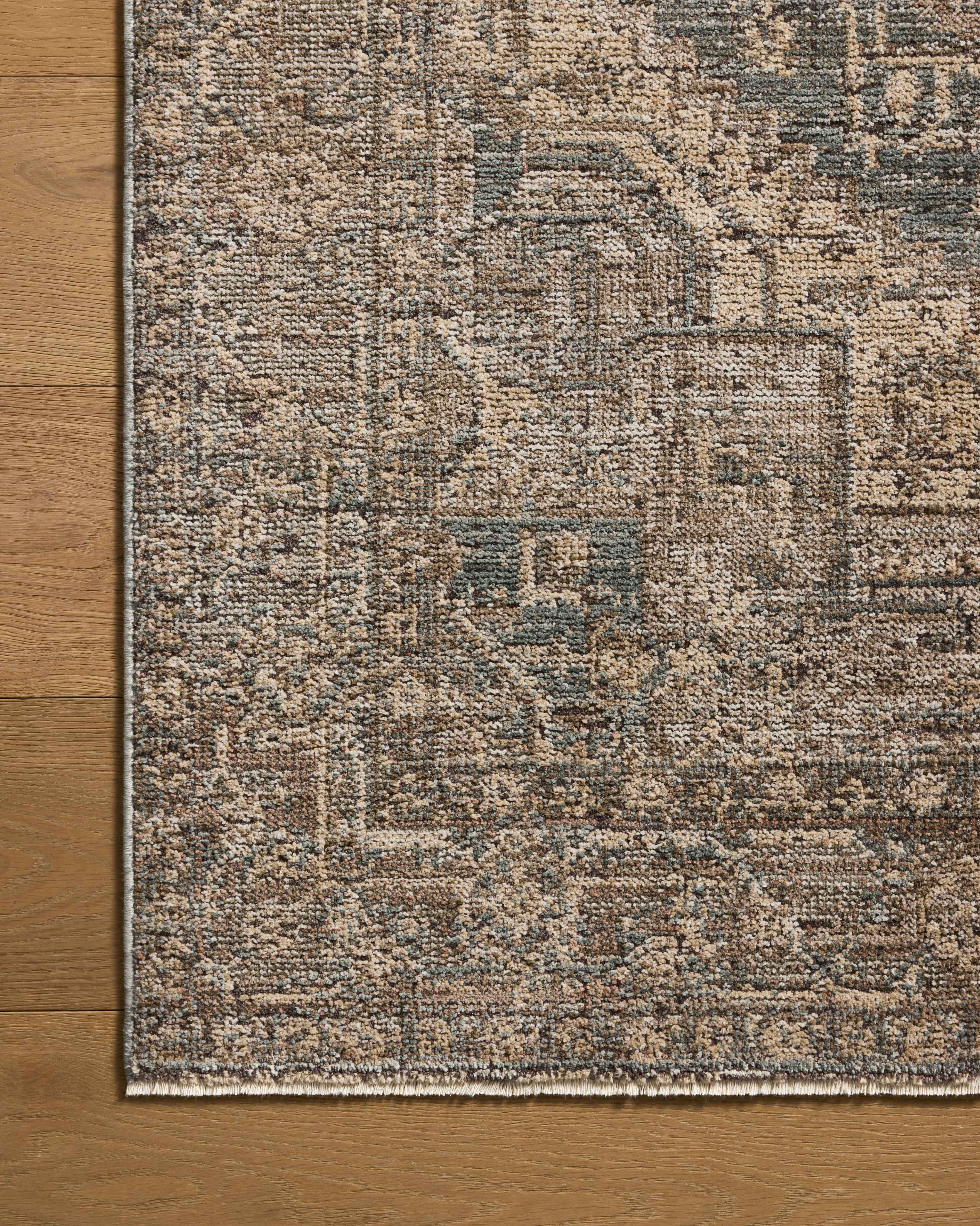 A power-loomed 100% polyester area rug with vintage flair in calming blue and grounded bark tones, the Priscilla PRL-04 Blue / Bark Area Rug anchors any room
