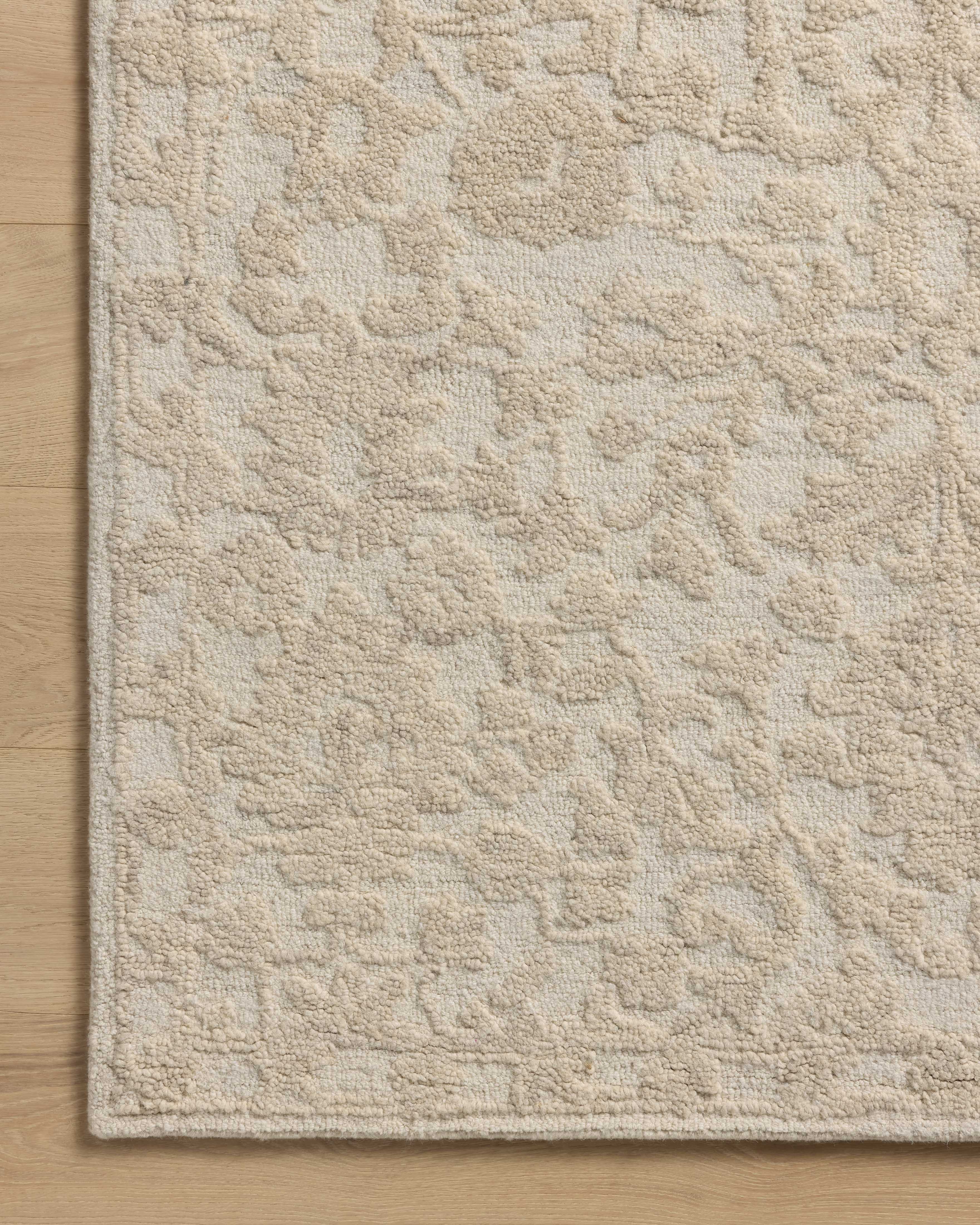 Featuring soft cream and refined ivory hues and floral detail, the Prudence PRU-01 Cream / Ivory Area Rug is a hand-tufted wool and cotton area rug for any room