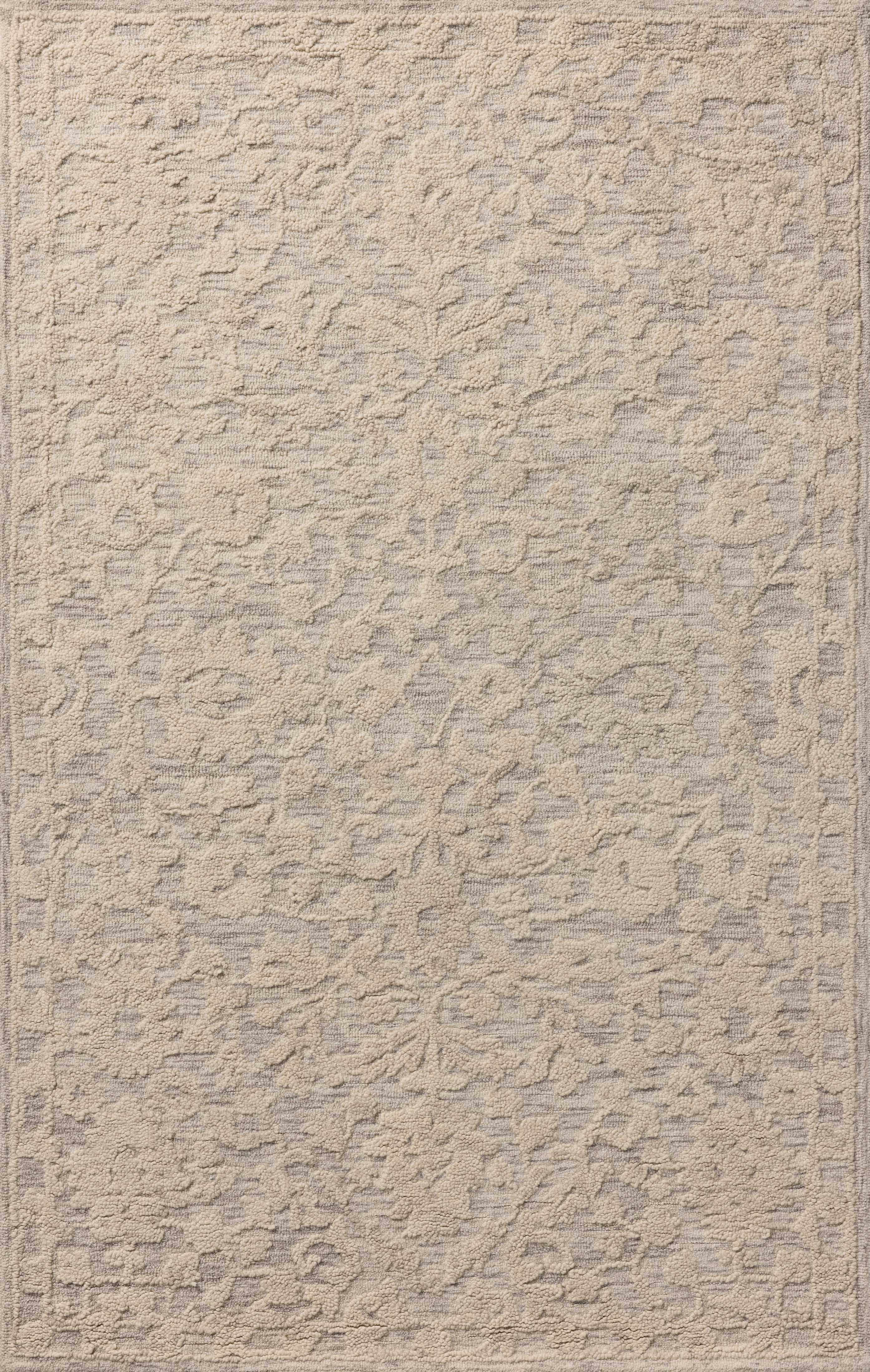 A hand-tufted wool and cotton area rug with floral flair in soft misty and refined ivory tones, the Prudence PRU-01 Mist / Ivory Area Rug anchors any room