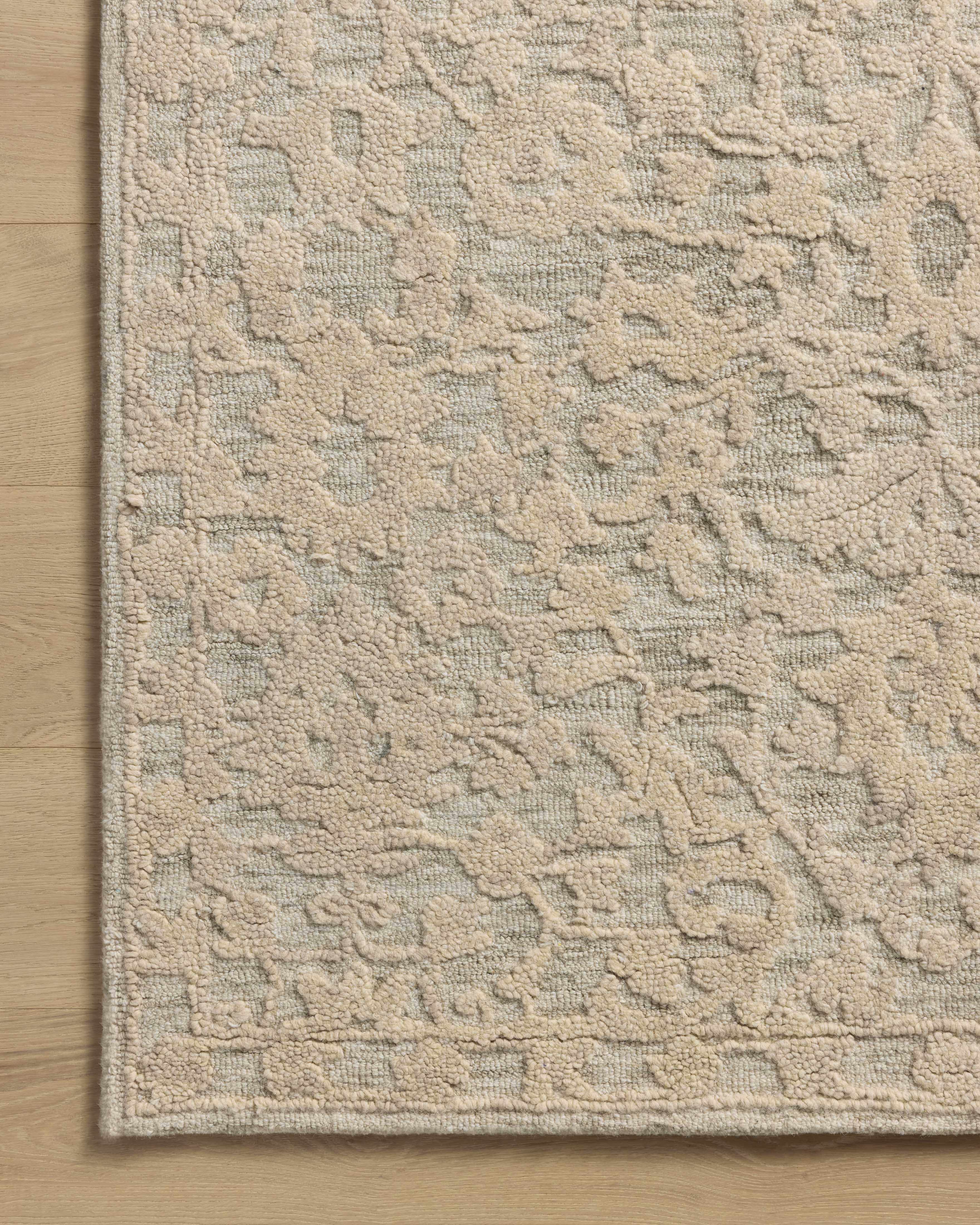 The Prudence PRU-01 Sage / Ivory Area Rug pairs calming sage and refined ivory tones and floral patterns in a hand-tufted wool and cotton area rug