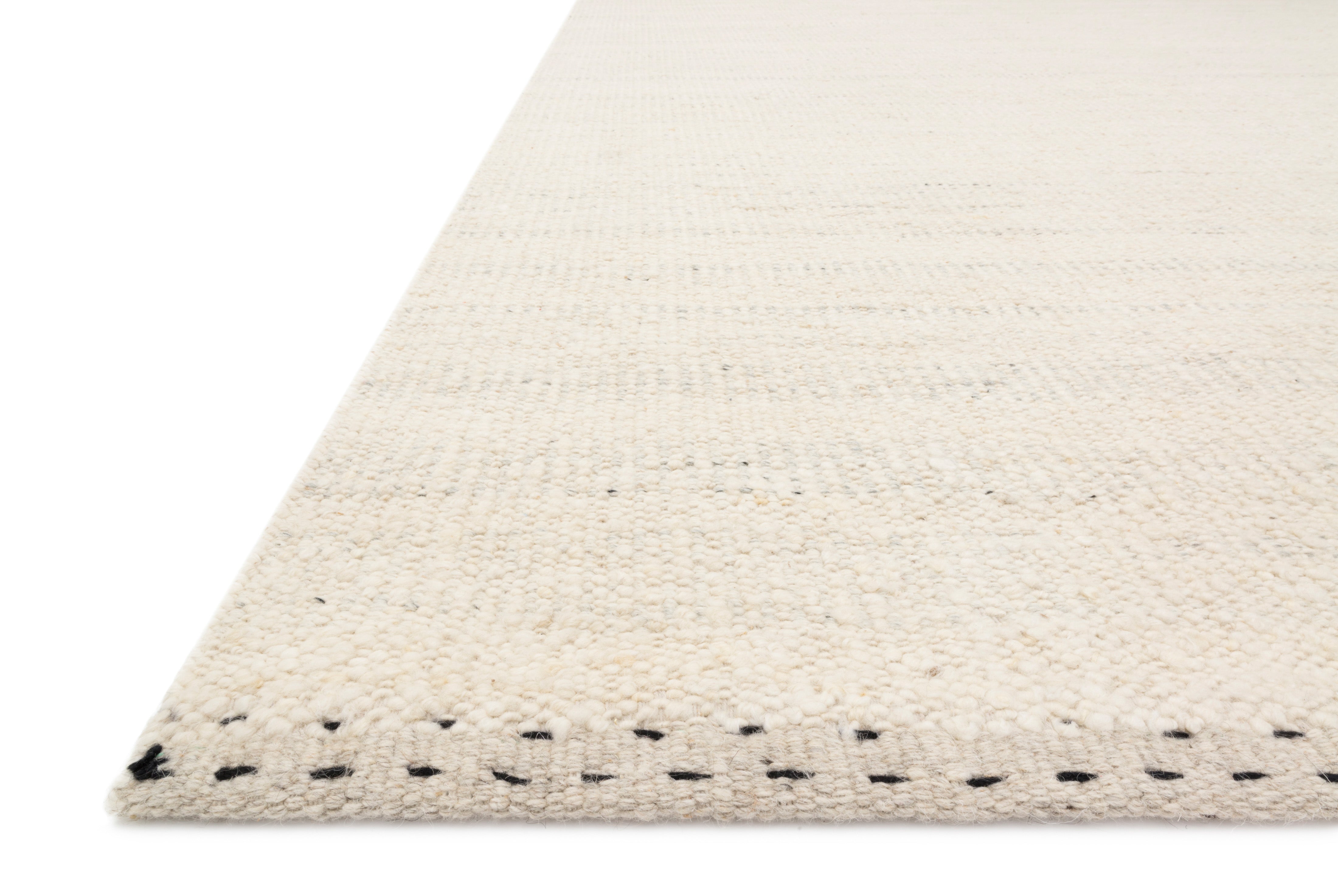 The Sloane SLN-01 Sky Area Rug pairs breezy sky-blue tones and bohemian and contemporary patterns in a hand-woven wool, cotton, and polyester area rug