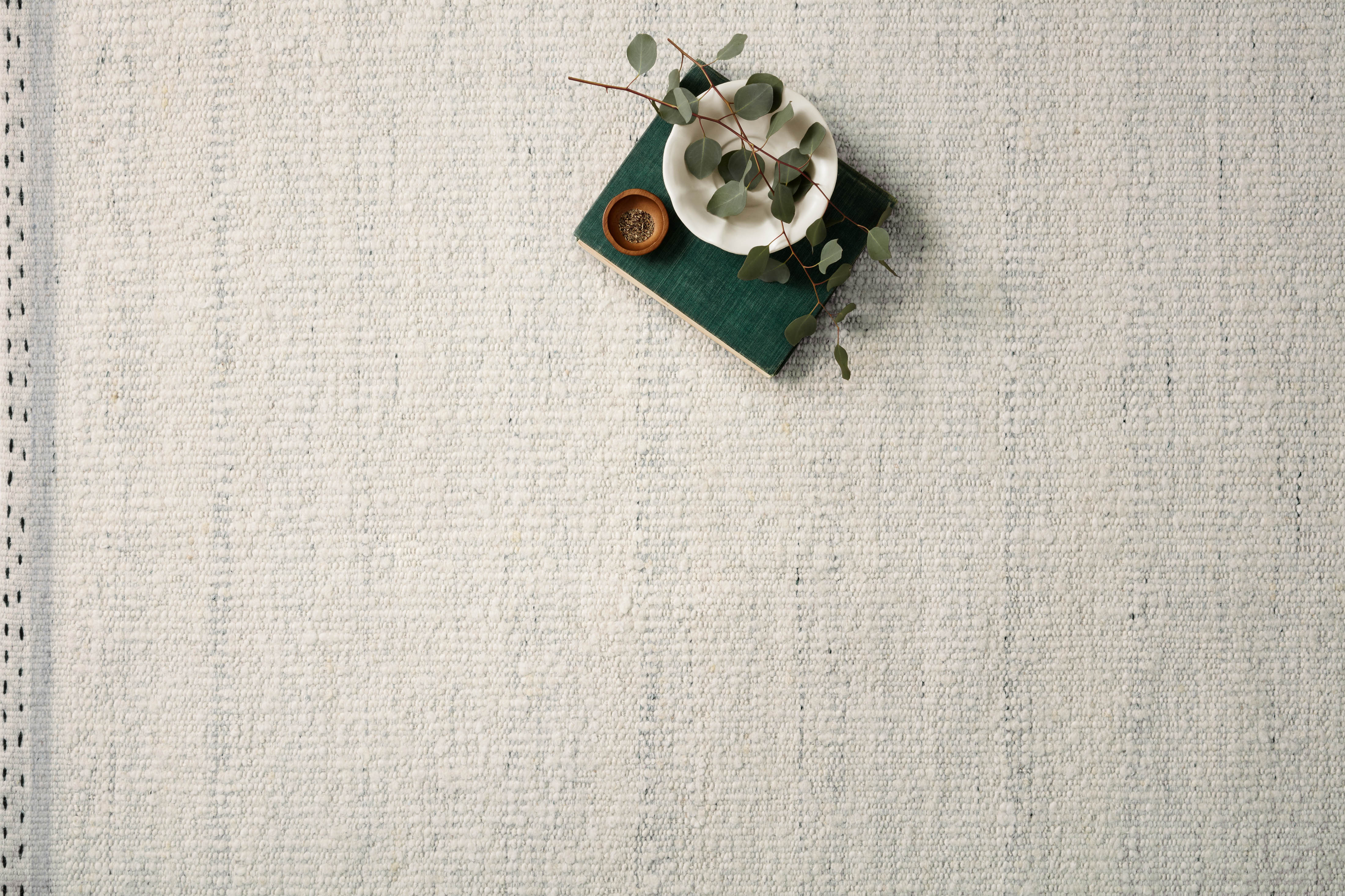Crafted as a hand-woven wool, cotton, and polyester area rug, the Sloane SLN-01 Smoke Area Rug brings smoky warmth and bohemian and contemporary character to your space