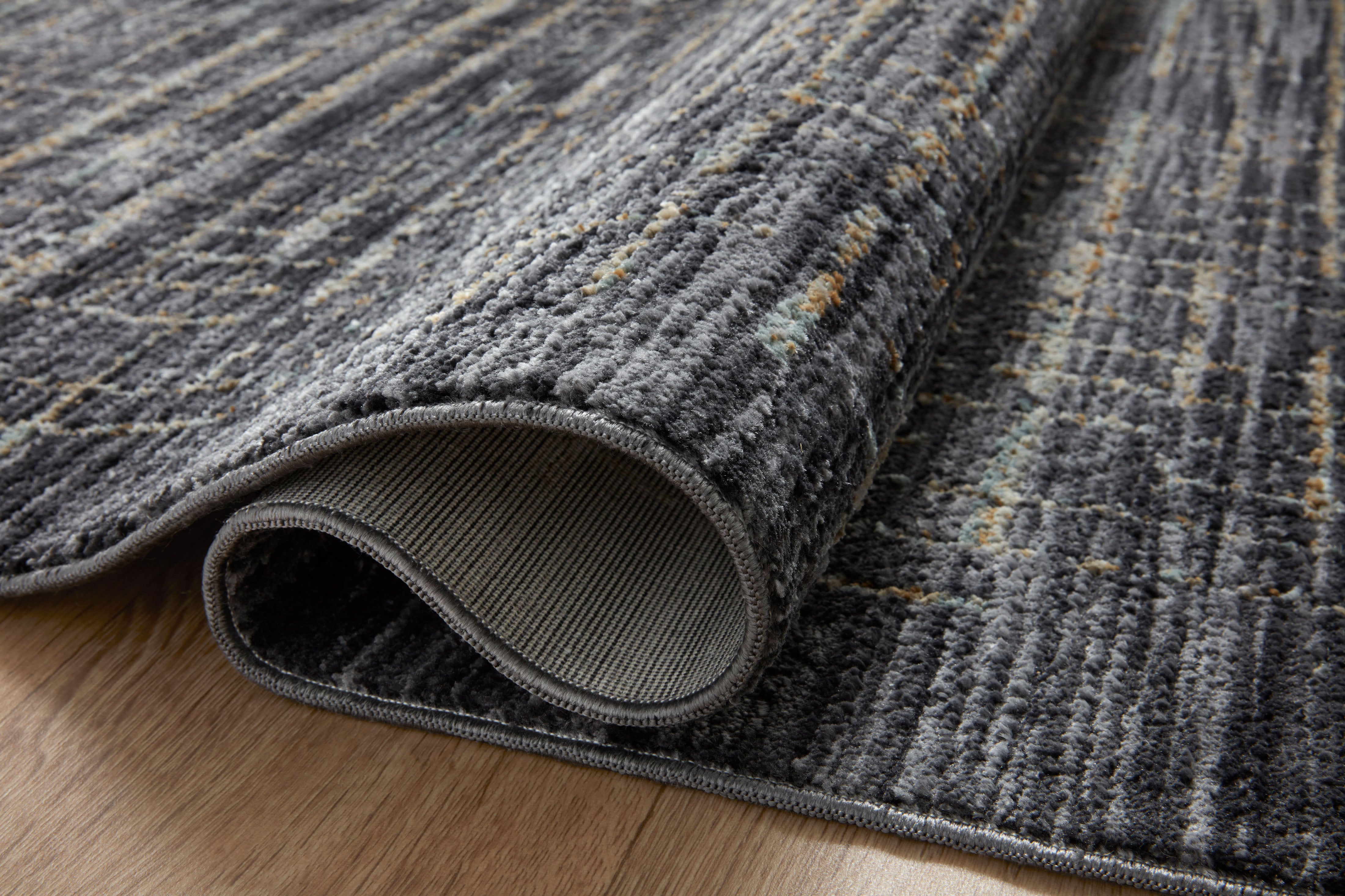 With bold onyx and shimmering silver hues and contemporary and abstract styling, the Soho SOH-01 Onyx / Silver Area Rug is a power-loomed 100% polyester area rug that elevates any room