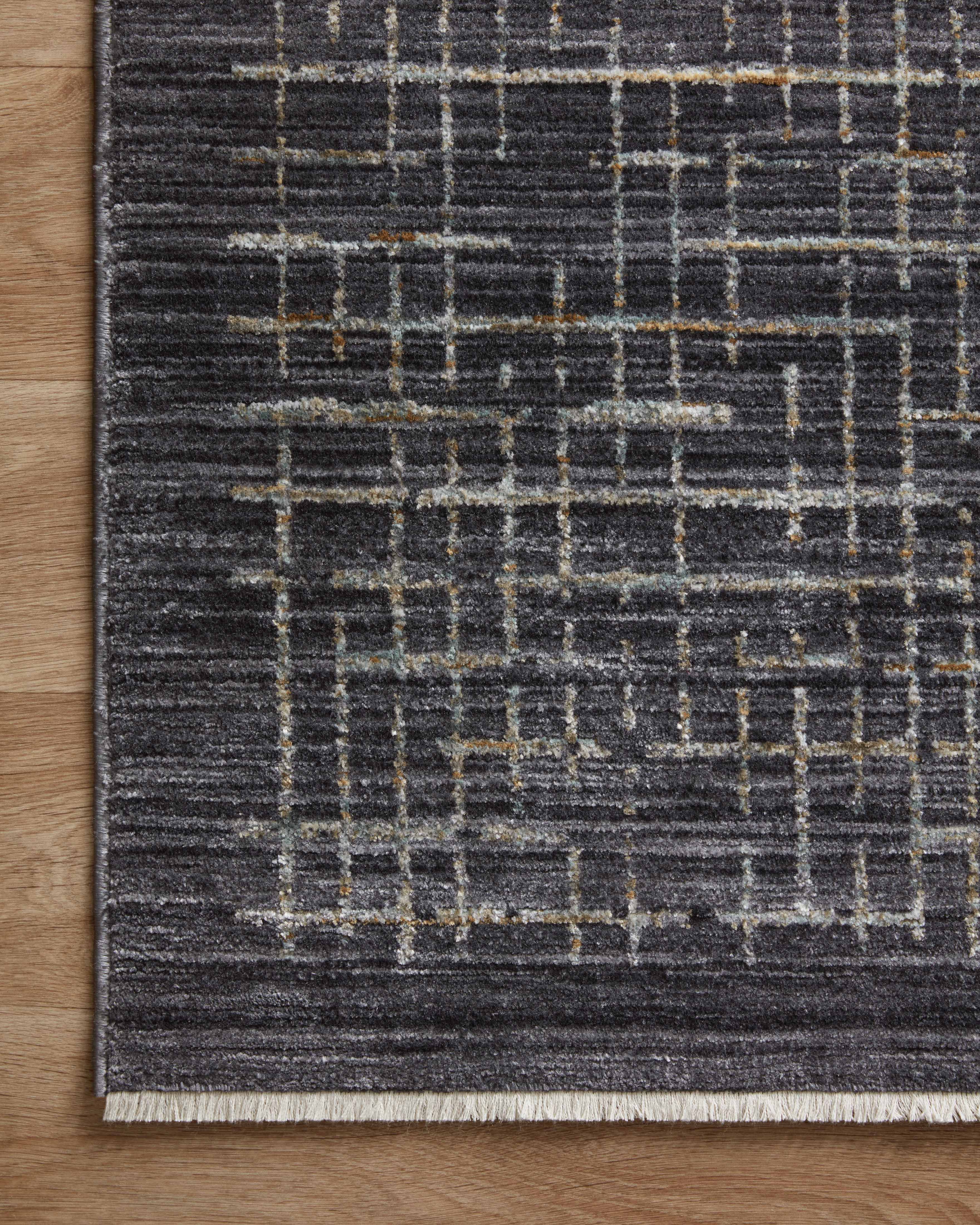 With bold onyx and shimmering silver hues and contemporary and abstract styling, the Soho SOH-01 Onyx / Silver Area Rug is a power-loomed 100% polyester area rug that elevates any room