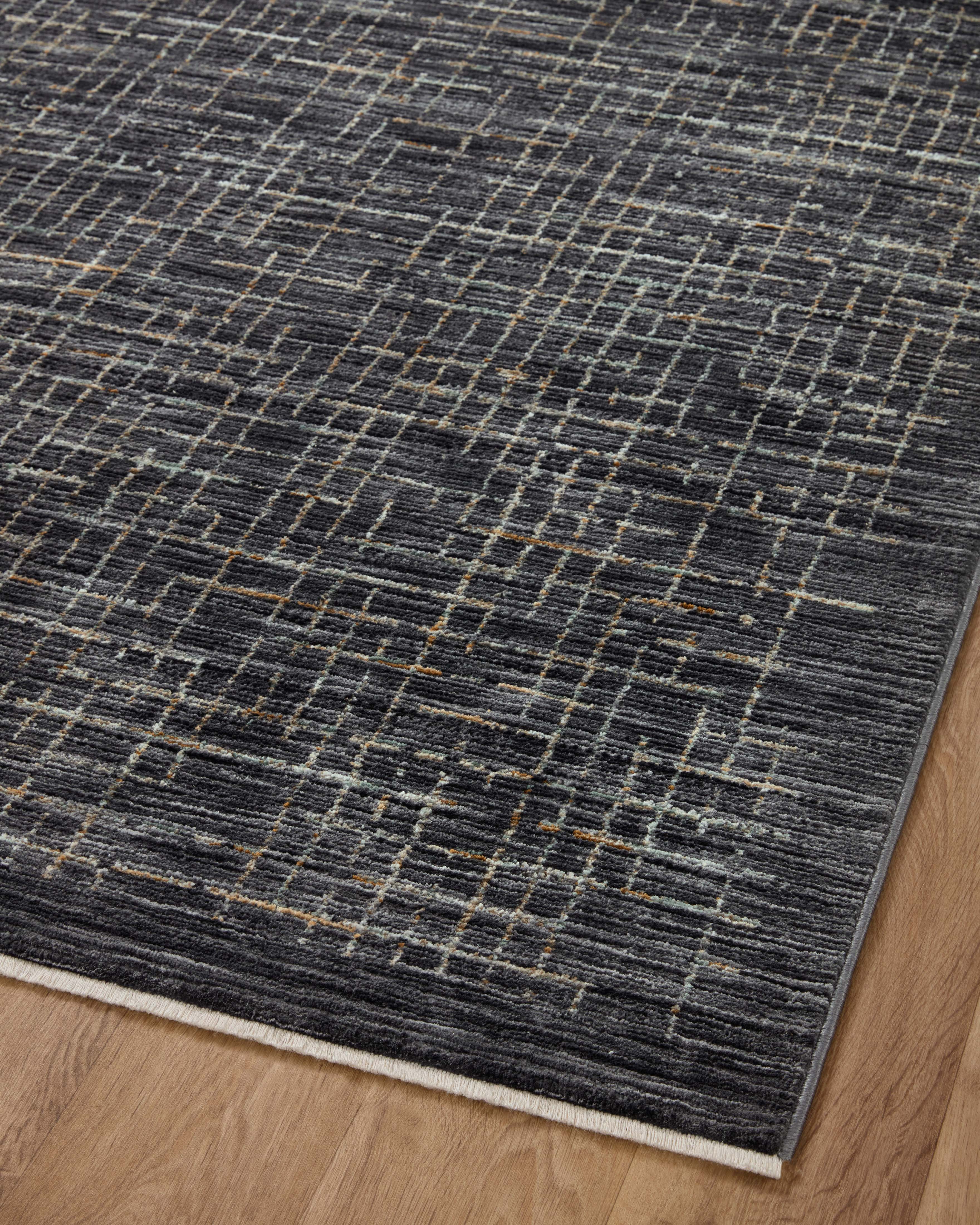 With bold onyx and shimmering silver hues and contemporary and abstract styling, the Soho SOH-01 Onyx / Silver Area Rug is a power-loomed 100% polyester area rug that elevates any room