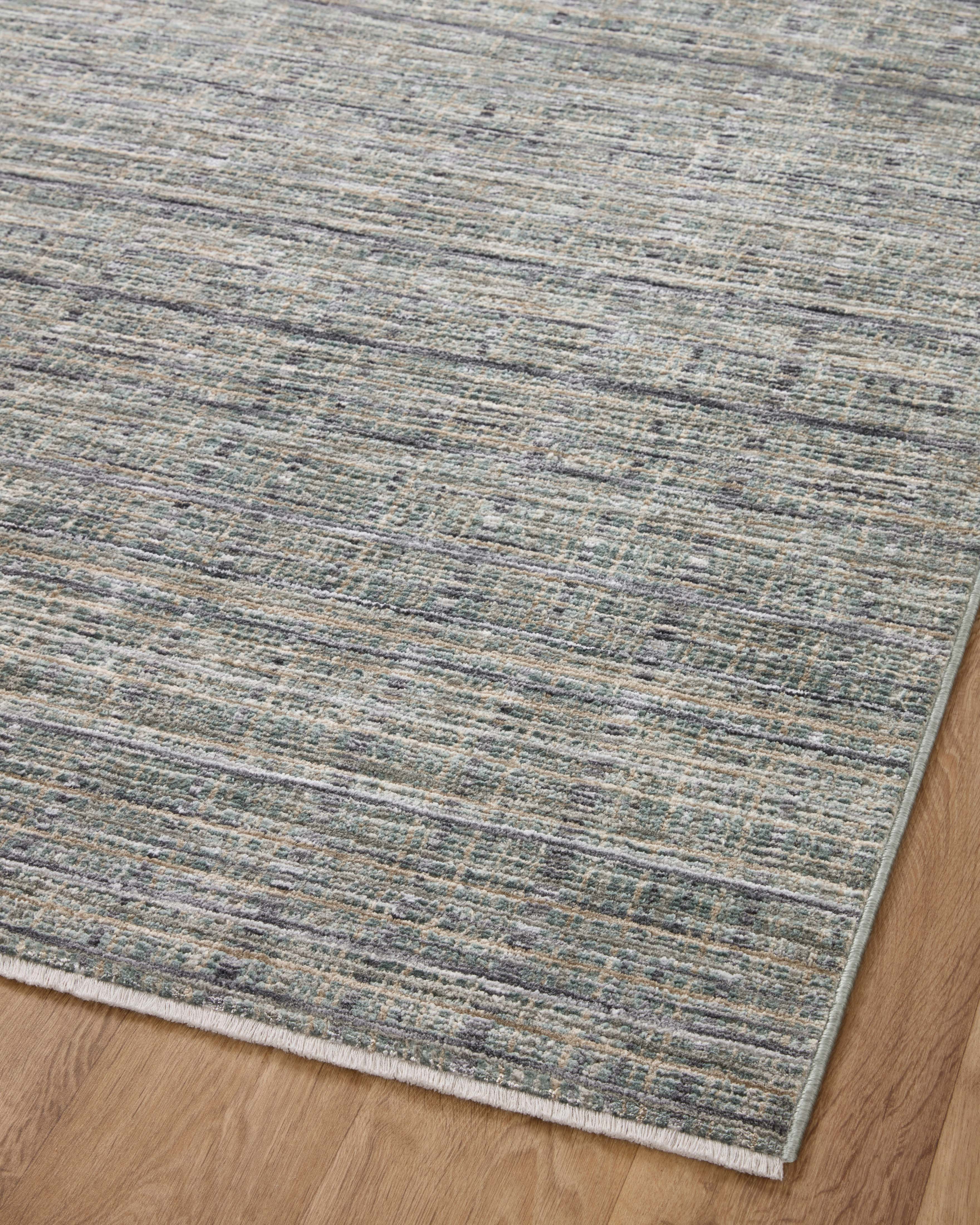 The Soho SOH-04 Jade / Stone Area Rug delivers refreshing jade and grounding stone beauty and contemporary and abstract elegance in a power-loomed 100% polyester area rug