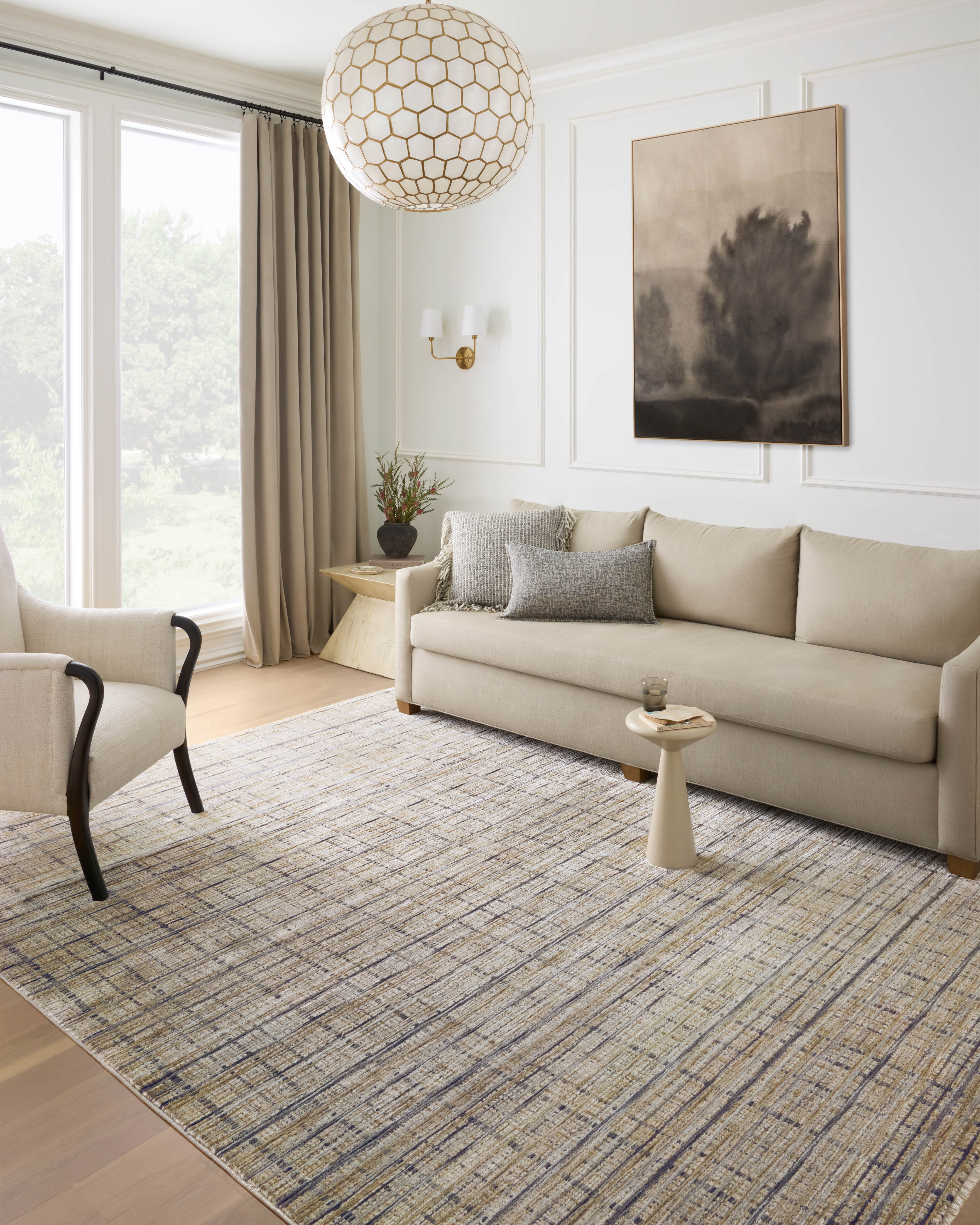 Designed with contemporary and abstract artistry in subtle pebble and deep charcoal hues, the Soho SOH-04 Pebble / Charcoal Area Rug is a power-loomed 100% polyester area rug that stands out