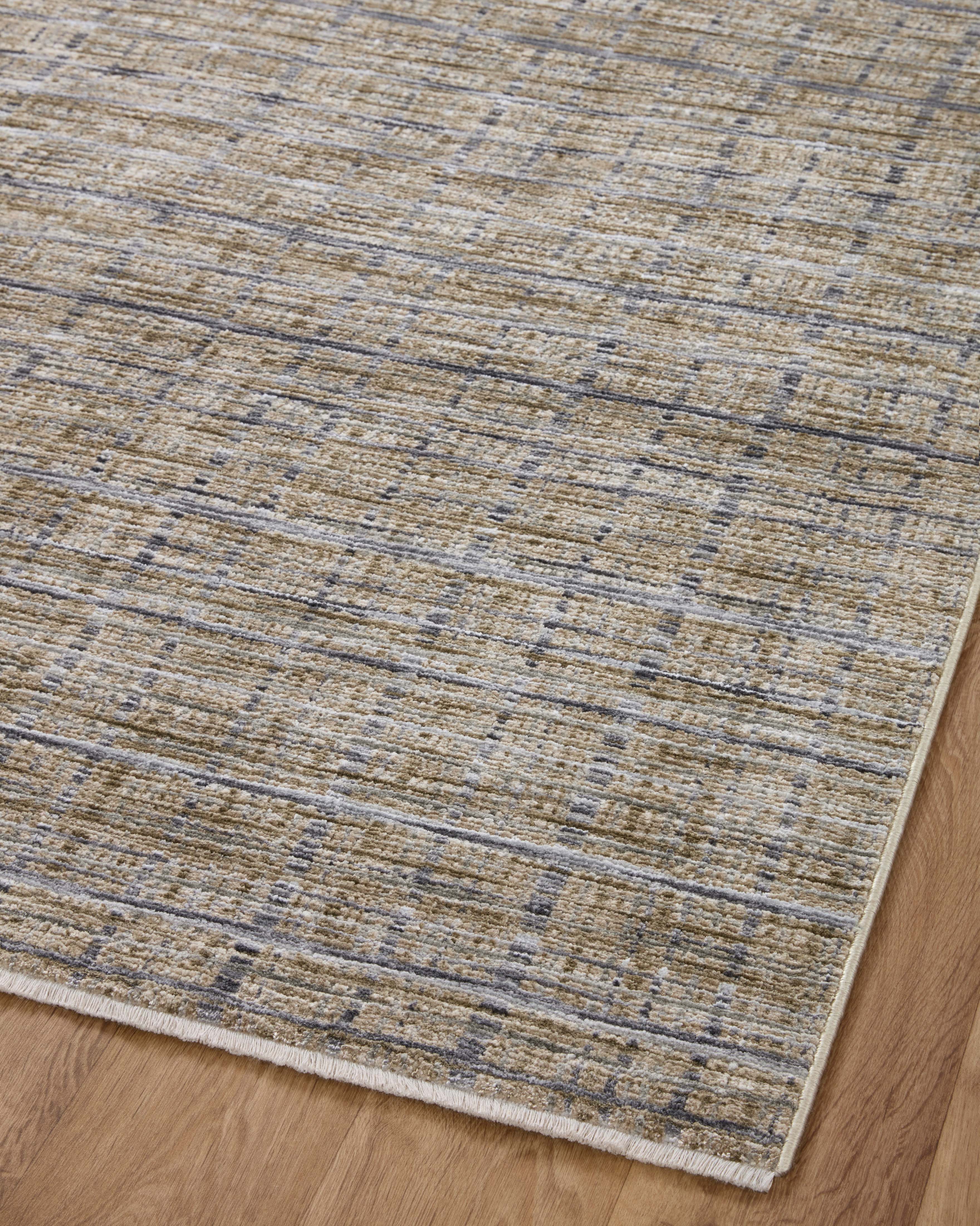Designed with contemporary and abstract artistry in subtle pebble and deep charcoal hues, the Soho SOH-04 Pebble / Charcoal Area Rug is a power-loomed 100% polyester area rug that stands out