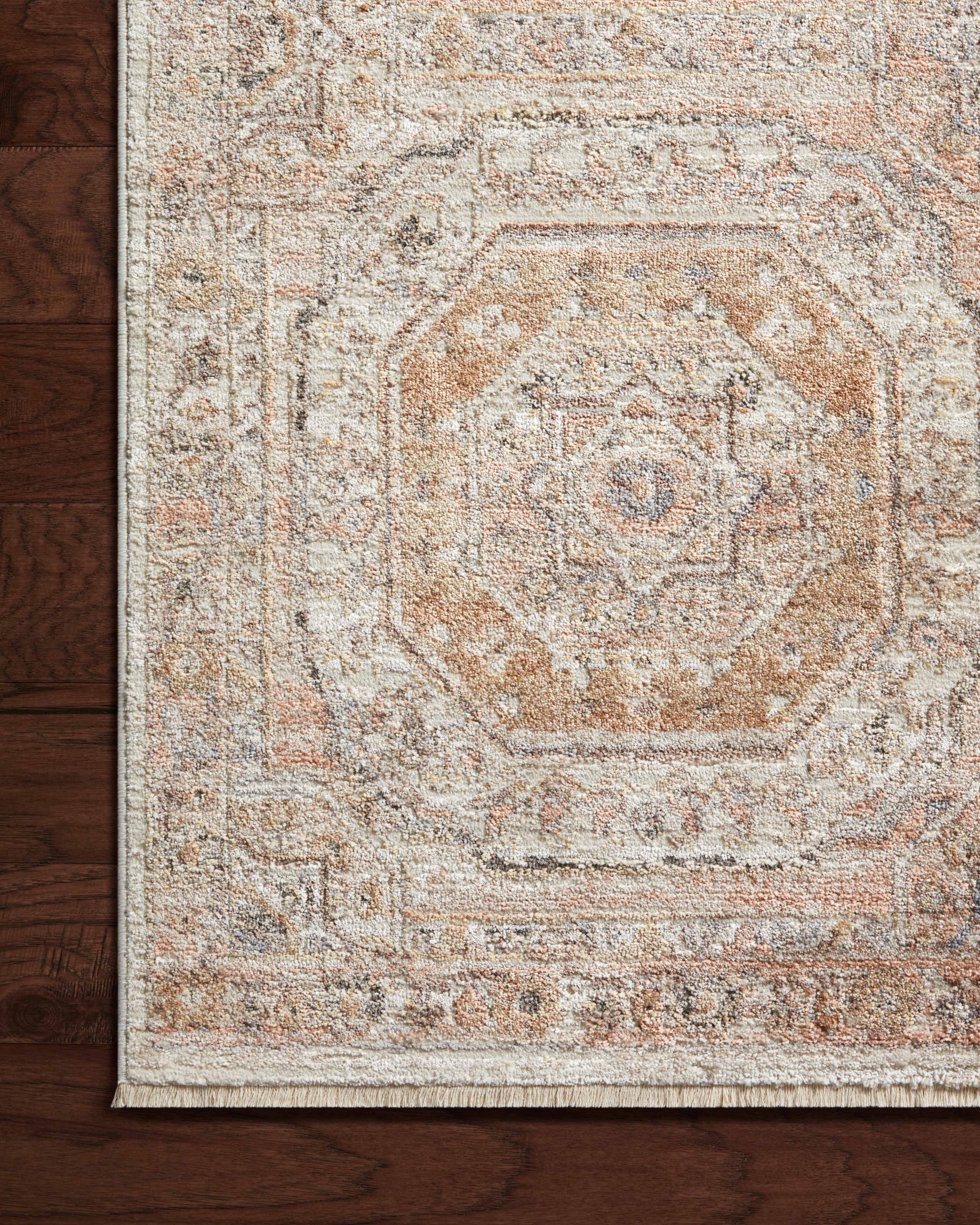 A power-loomed polypropylene and polyester area rug in warm apricot and vibrant multi-toned tones with traditional motifs, the Sonnet SNN-06 Apricot / Multi Area Rug grounds your room beautifully