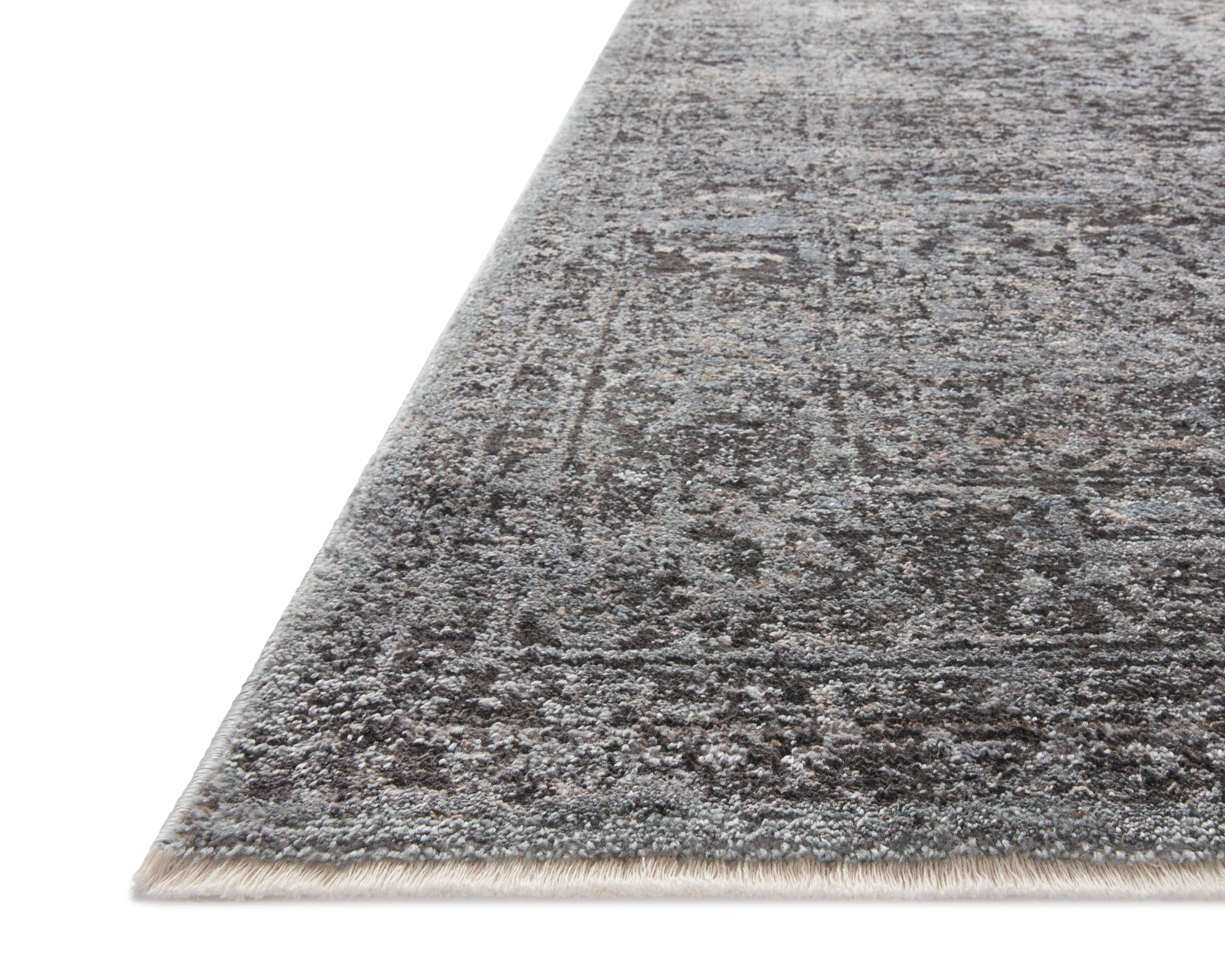 The Sonnet SNN-07 Charcoal / Mist Area Rug is a power-loomed polypropylene and polyester area rug that radiates deep charcoal and soft misty charm and traditional elegance