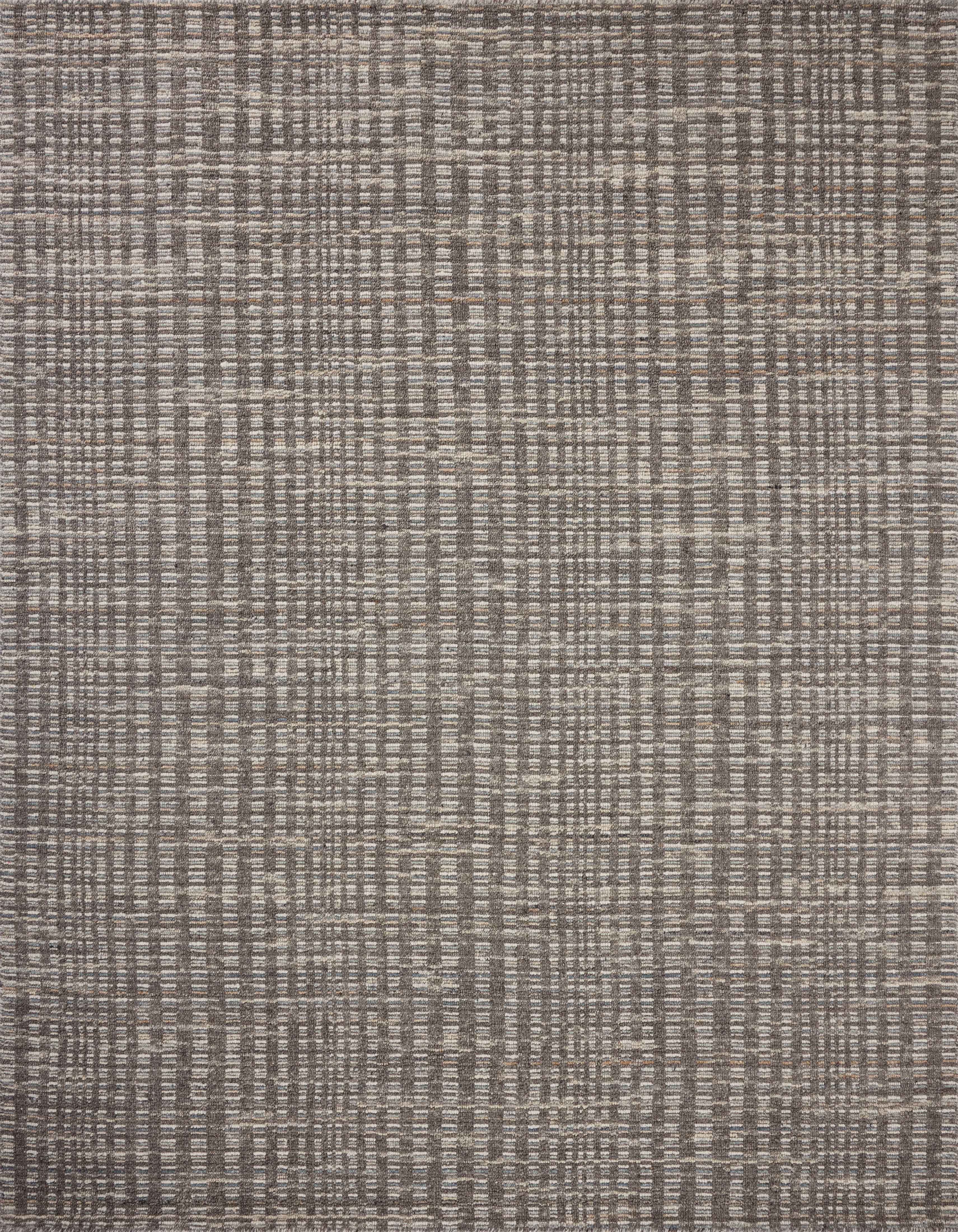 Dressed in striking granite and vibrant multi-toned hues with graphic detail, the Sonya SOY-05 Granite / Multi Area Rug is a hand-loomed wool area rug that completes any room