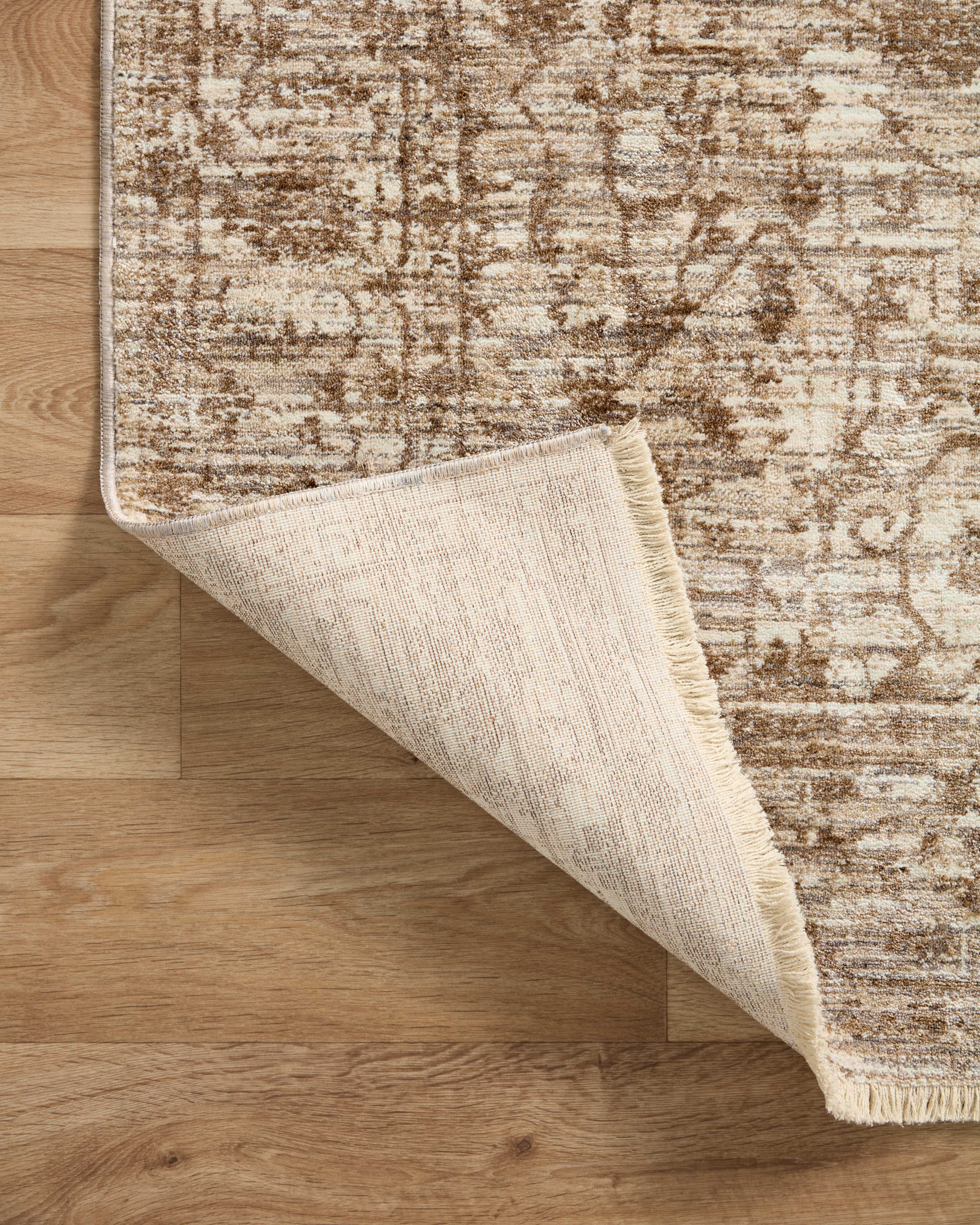 A power-loomed 100% polyester area rug with vintage flair in grounded bark and warm natural tones, the Sorrento SOR-01 Bark / Natural Area Rug anchors any room