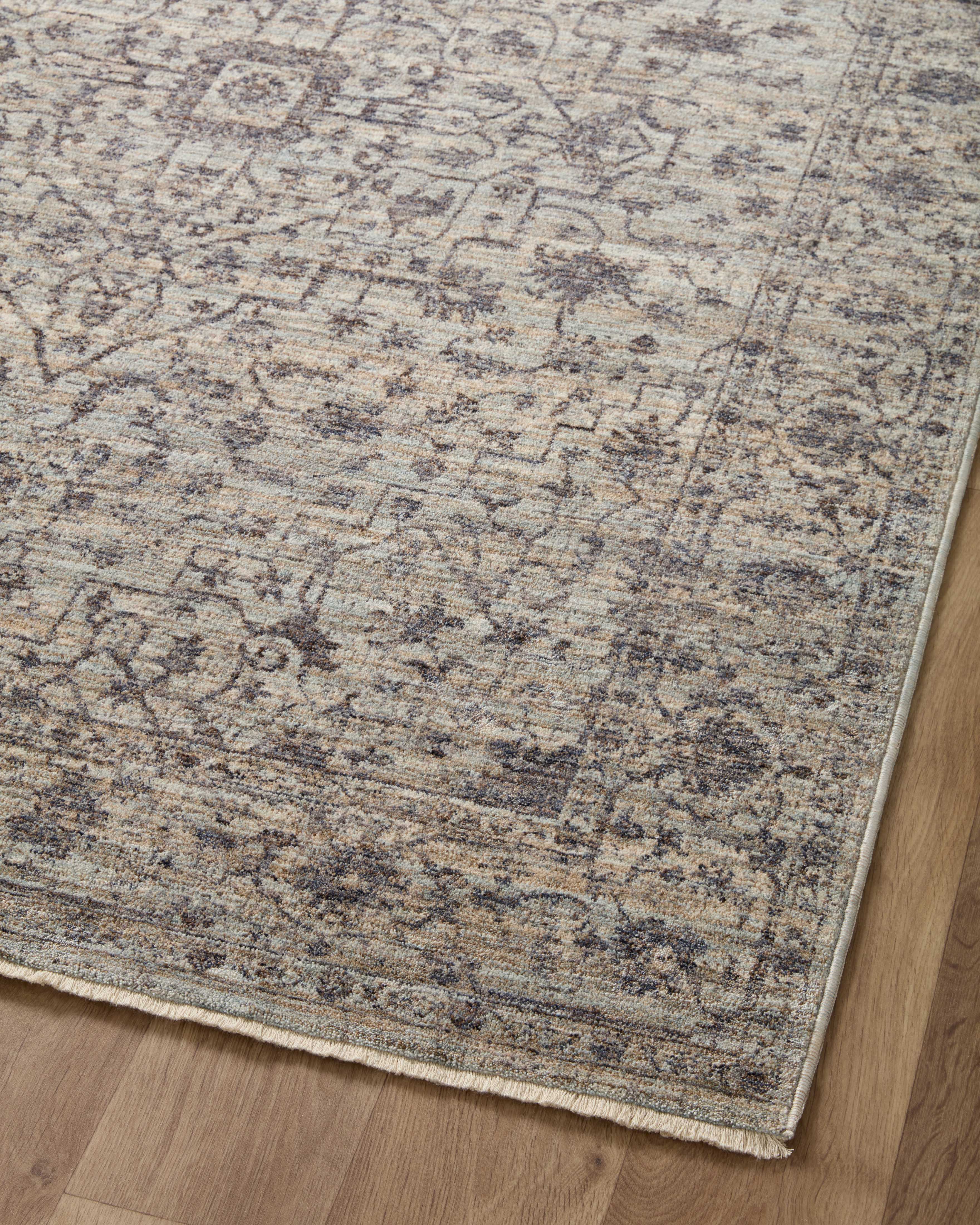 Crafted as a power-loomed 100% polyester area rug, the Sorrento SOR-01 Mist / Charcoal Area Rug brings soft misty and deep charcoal warmth and vintage character to your space