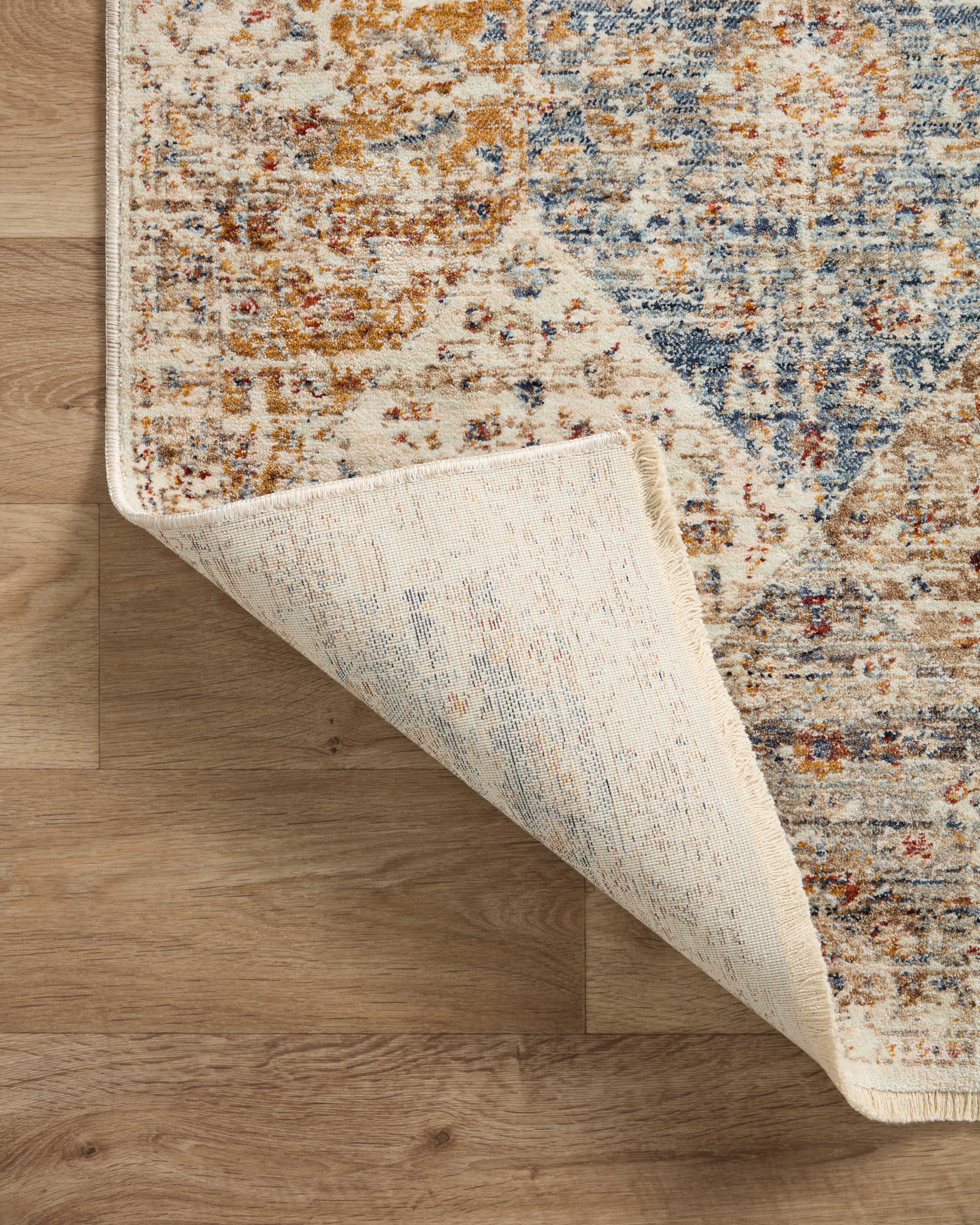 With refined ivory and vibrant multi-toned hues and vintage styling, the Sorrento SOR-02 Ivory / Multi Area Rug is a power-loomed 100% polyester area rug that elevates any room