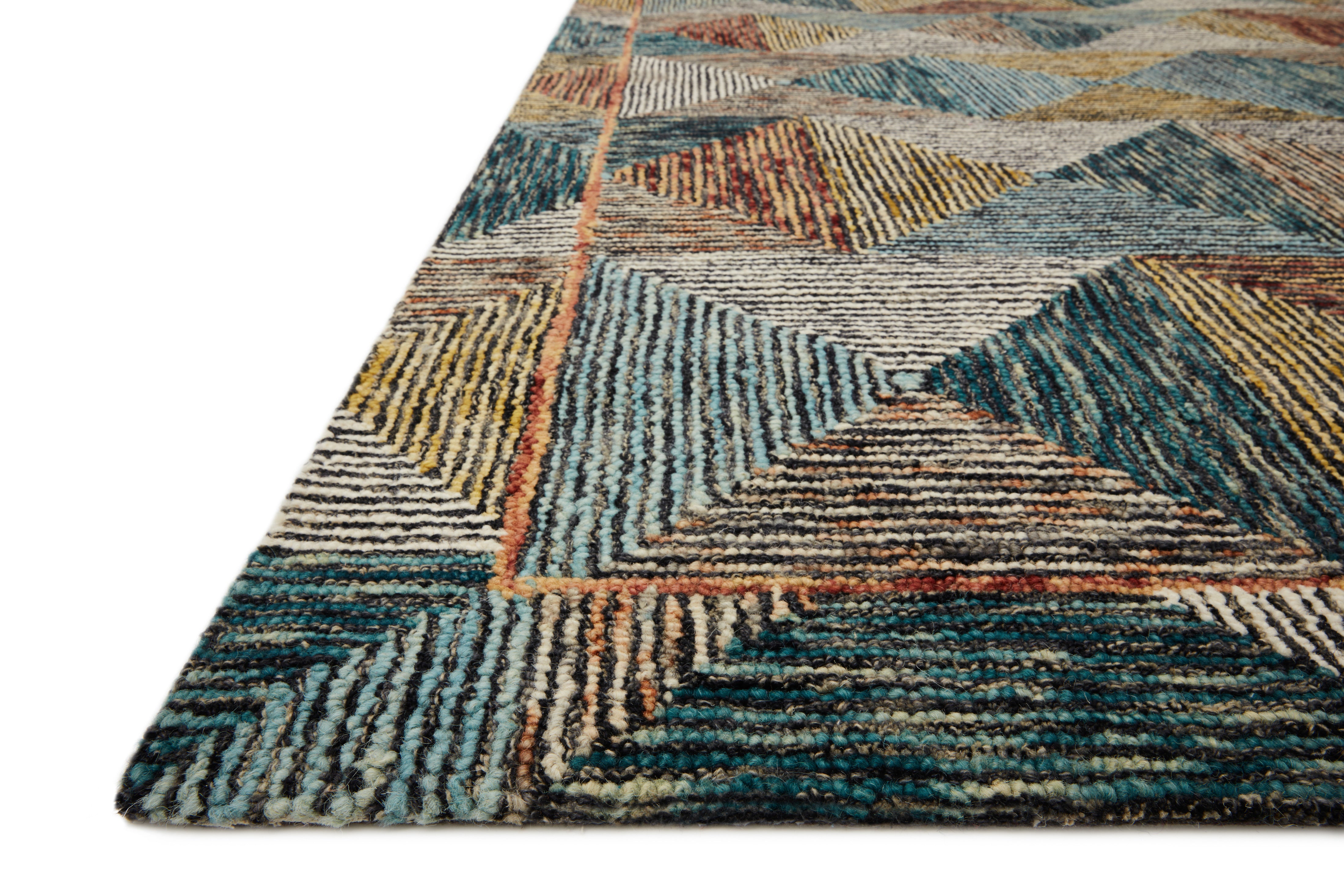 A hooked wool area rug featuring geometric and eclectic design and tranquil lagoon and spirited spice tones, the Spectrum SPE-01 Lagoon / Spice Area Rug adds character to any room