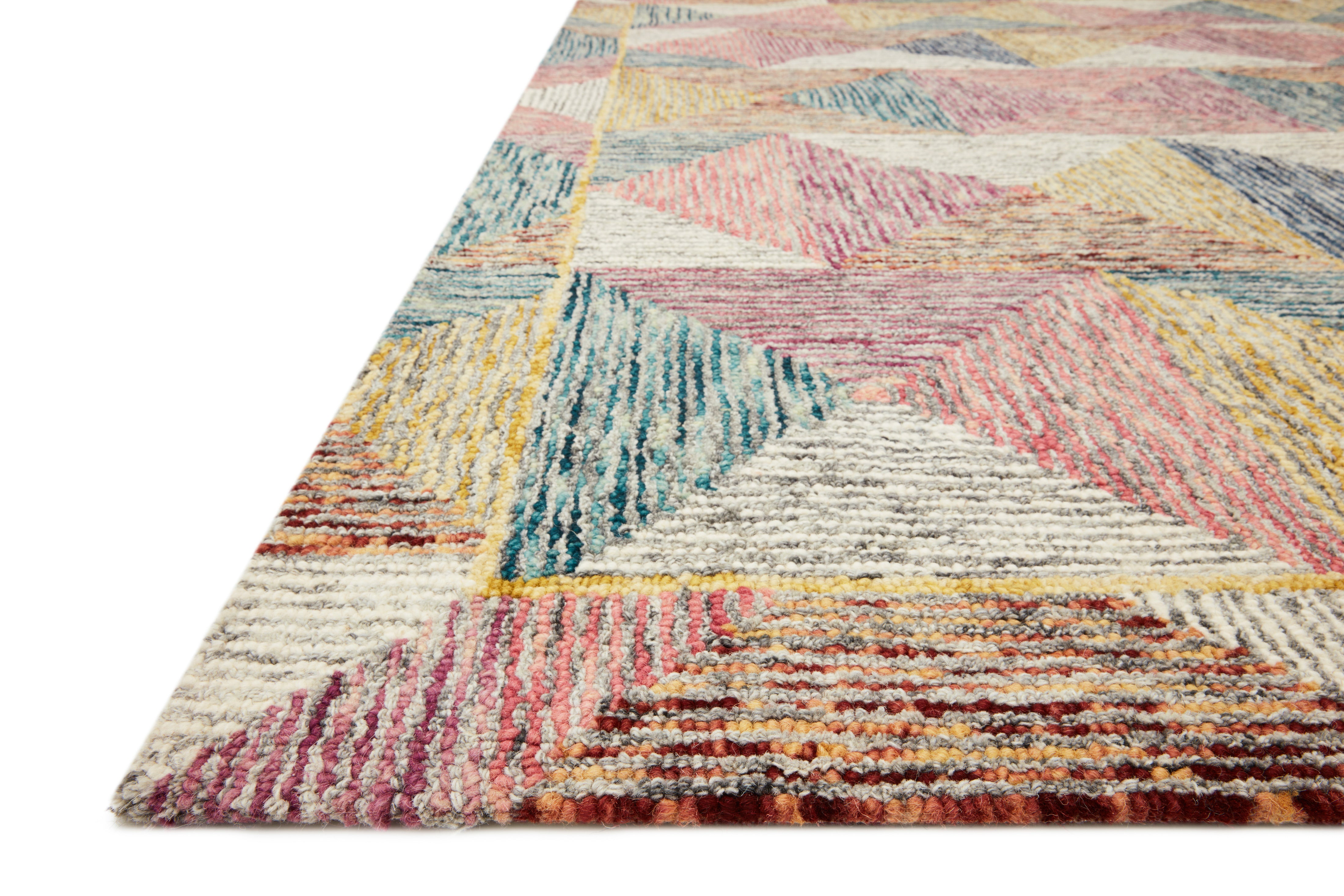 Rich in shimmering silver and lively fiesta hues with geometric and eclectic detail, the Spectrum SPE-01 Silver / Fiesta Area Rug is a hooked wool area rug built for style and comfort