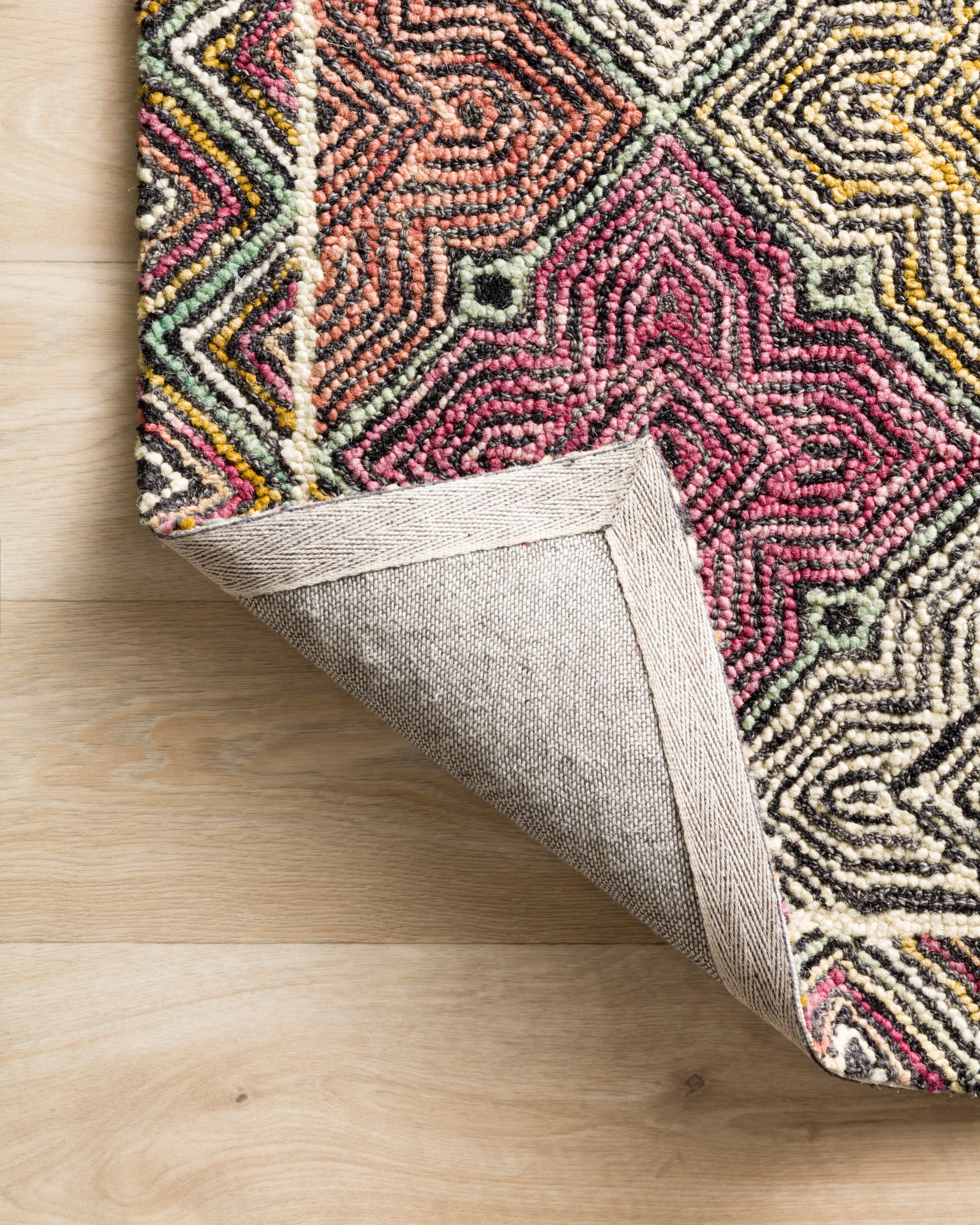 The Spectrum SPE-03 Charcoal / Multi Area Rug brings deep charcoal and vibrant multi-toned character and geometric and eclectic flair to your home in a hooked wool area rug