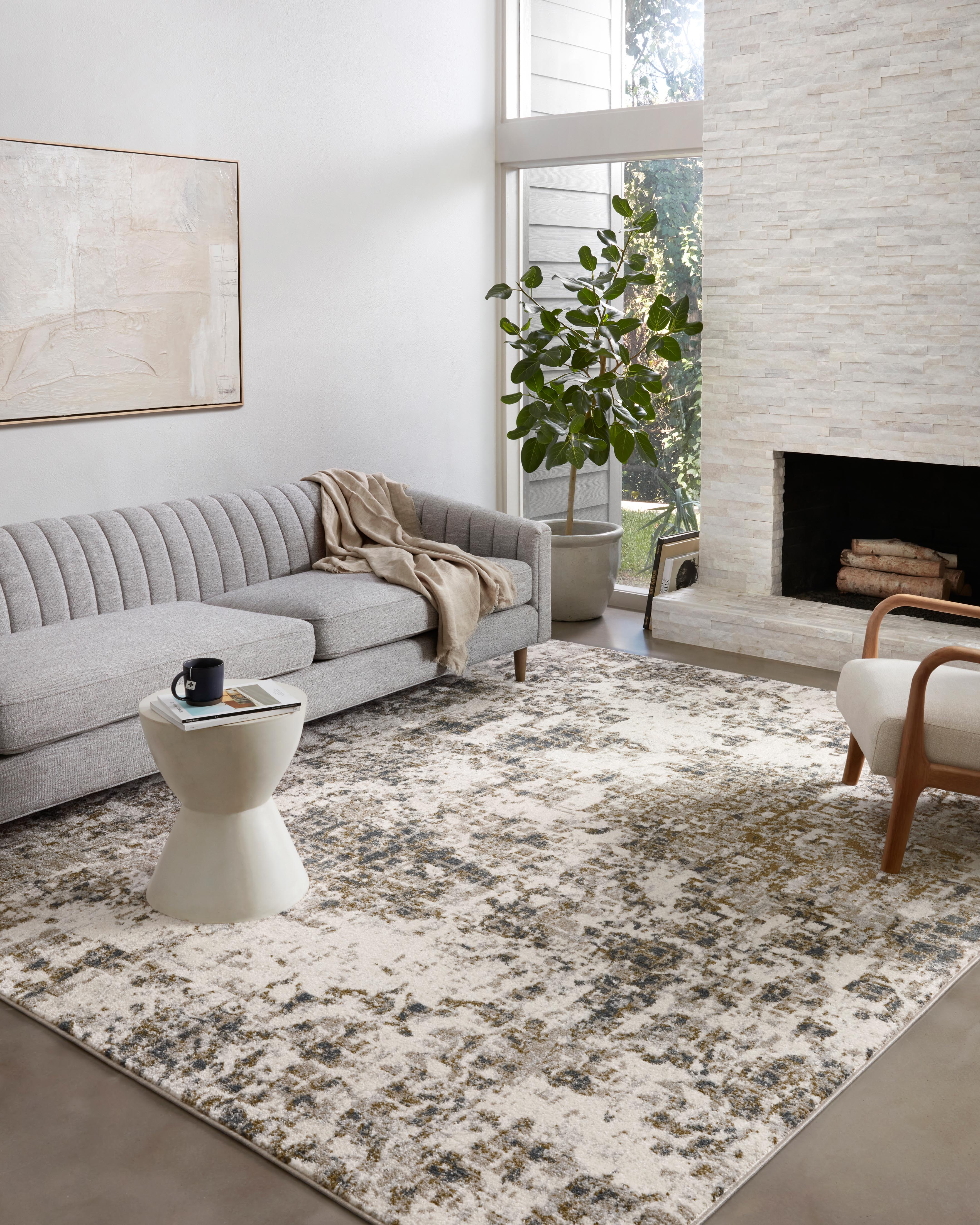 Finished in distinctive pewter and earthy olive tones with abstract styling, the Spirit SPI-01 Pewter / Olive Area Rug is a power-loomed 100% polypropylene area rug for modern living