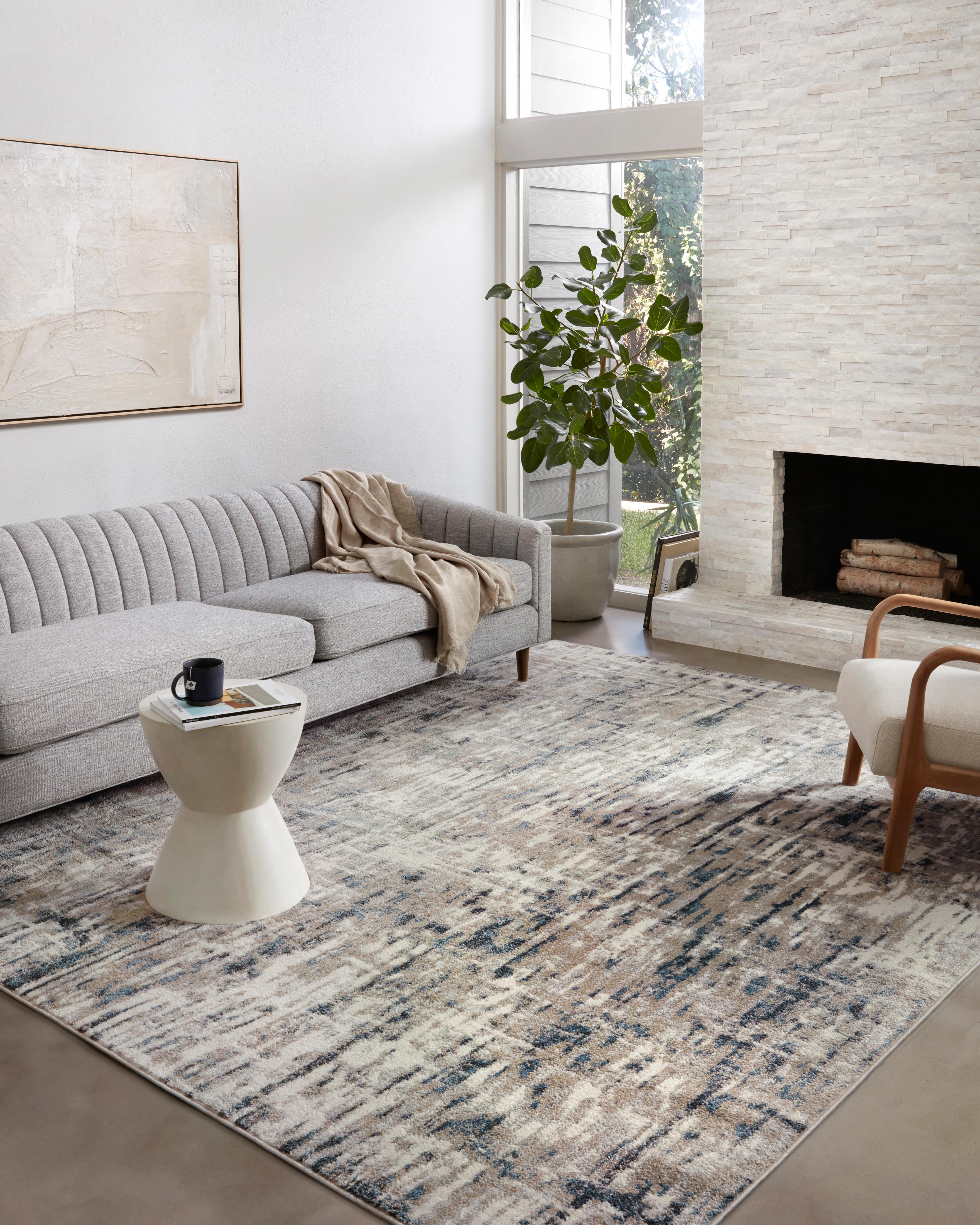 A power-loomed 100% polypropylene area rug with abstract design in grounding stone and calming blue hues, the Spirit SPI-02 Stone / Blue Area Rug is a standout in any décor