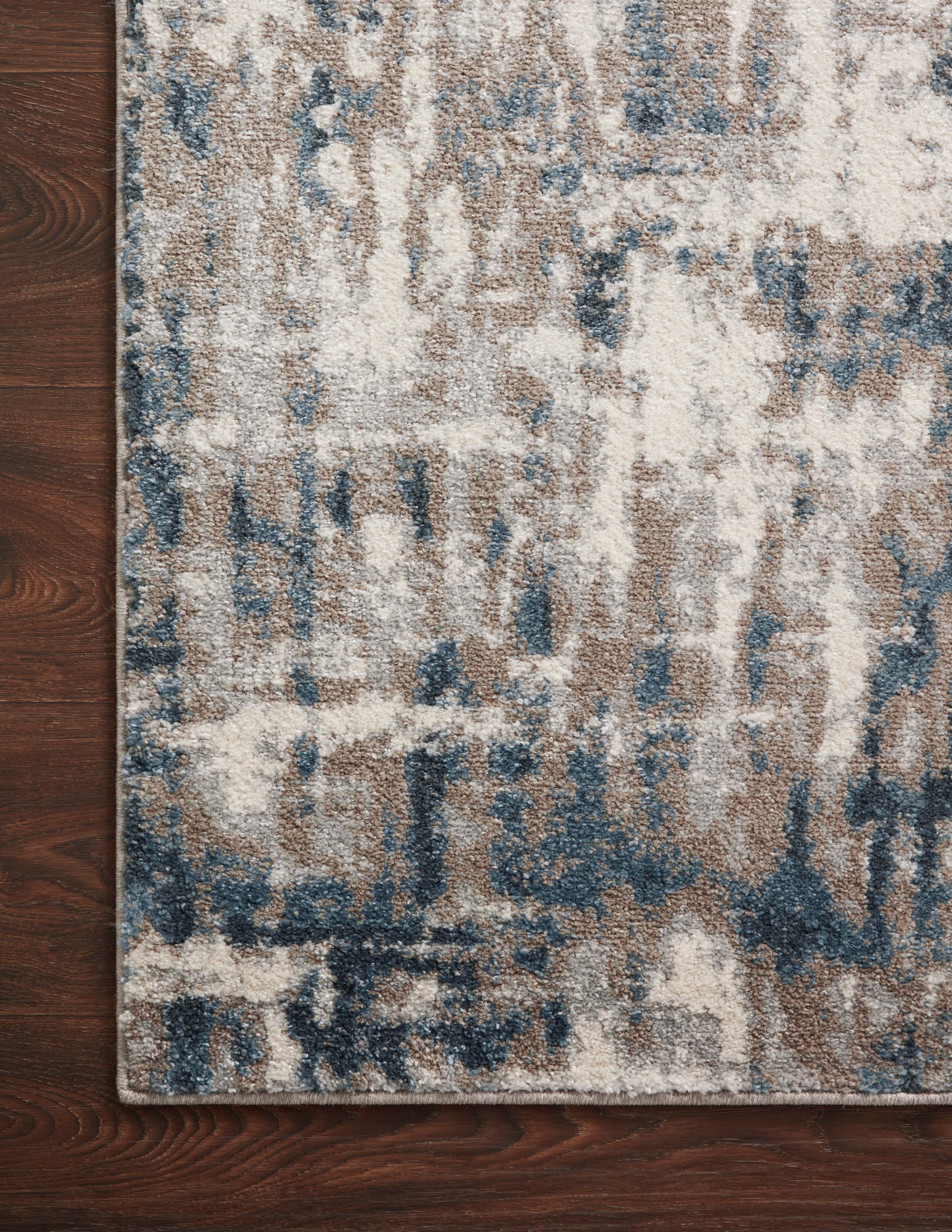 A power-loomed 100% polypropylene area rug with abstract design in grounding stone and calming blue hues, the Spirit SPI-02 Stone / Blue Area Rug is a standout in any décor