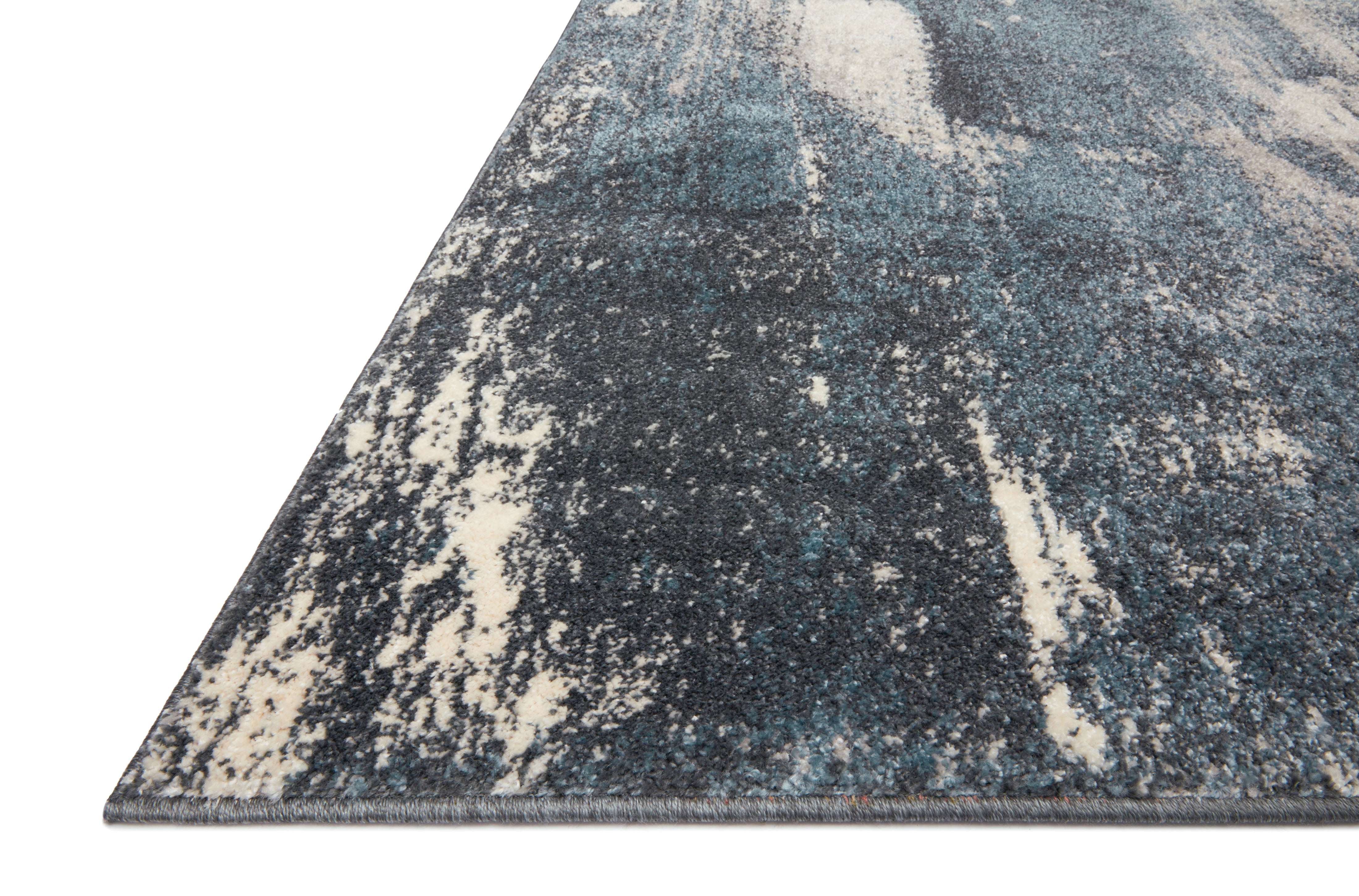Dressed in deep indigo and refined ivory hues with abstract detail, the Spirit SPI-04 Indigo / Ivory Area Rug is a power-loomed 100% polypropylene area rug that completes any room