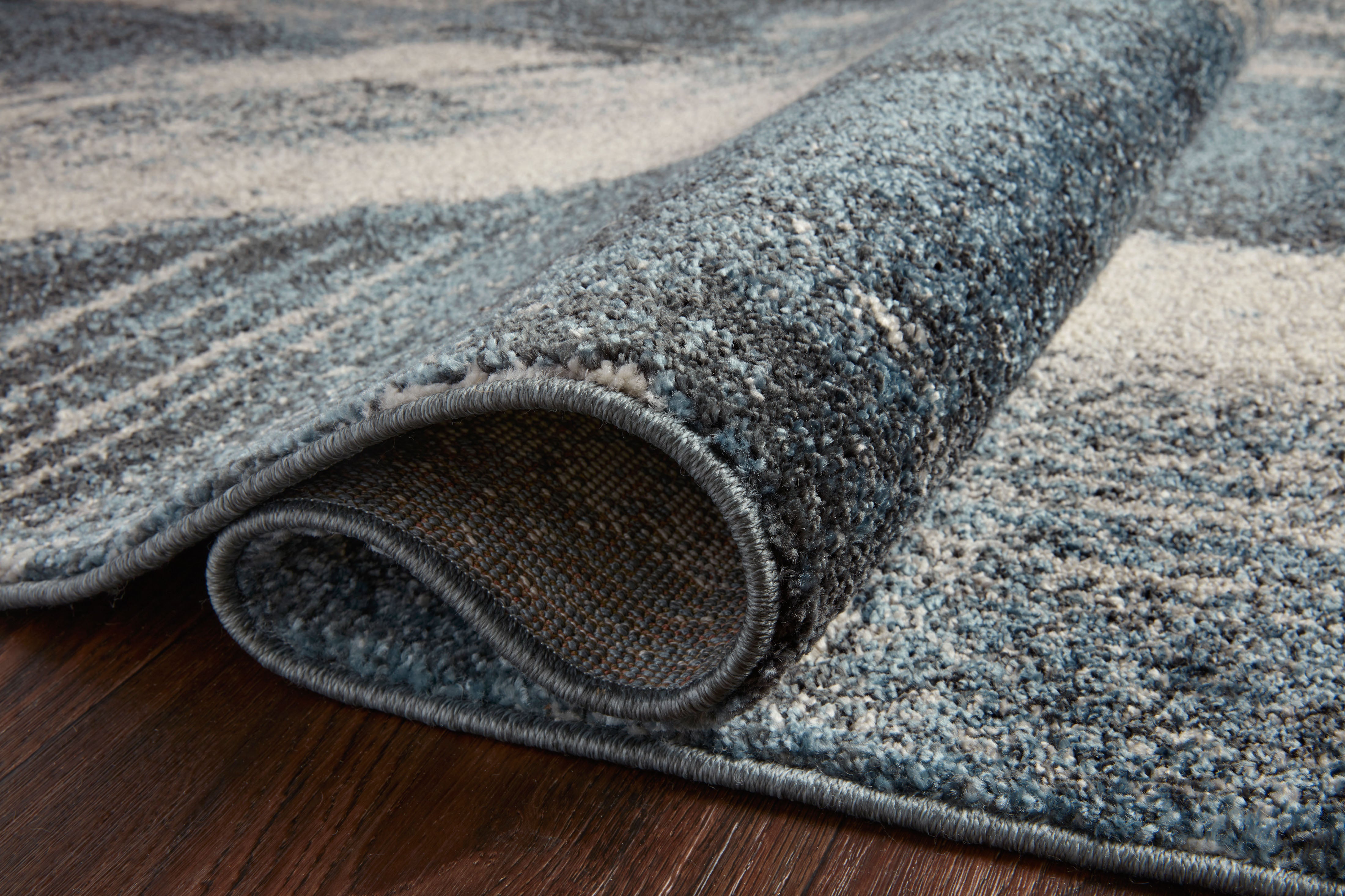 Dressed in deep indigo and refined ivory hues with abstract detail, the Spirit SPI-04 Indigo / Ivory Area Rug is a power-loomed 100% polypropylene area rug that completes any room