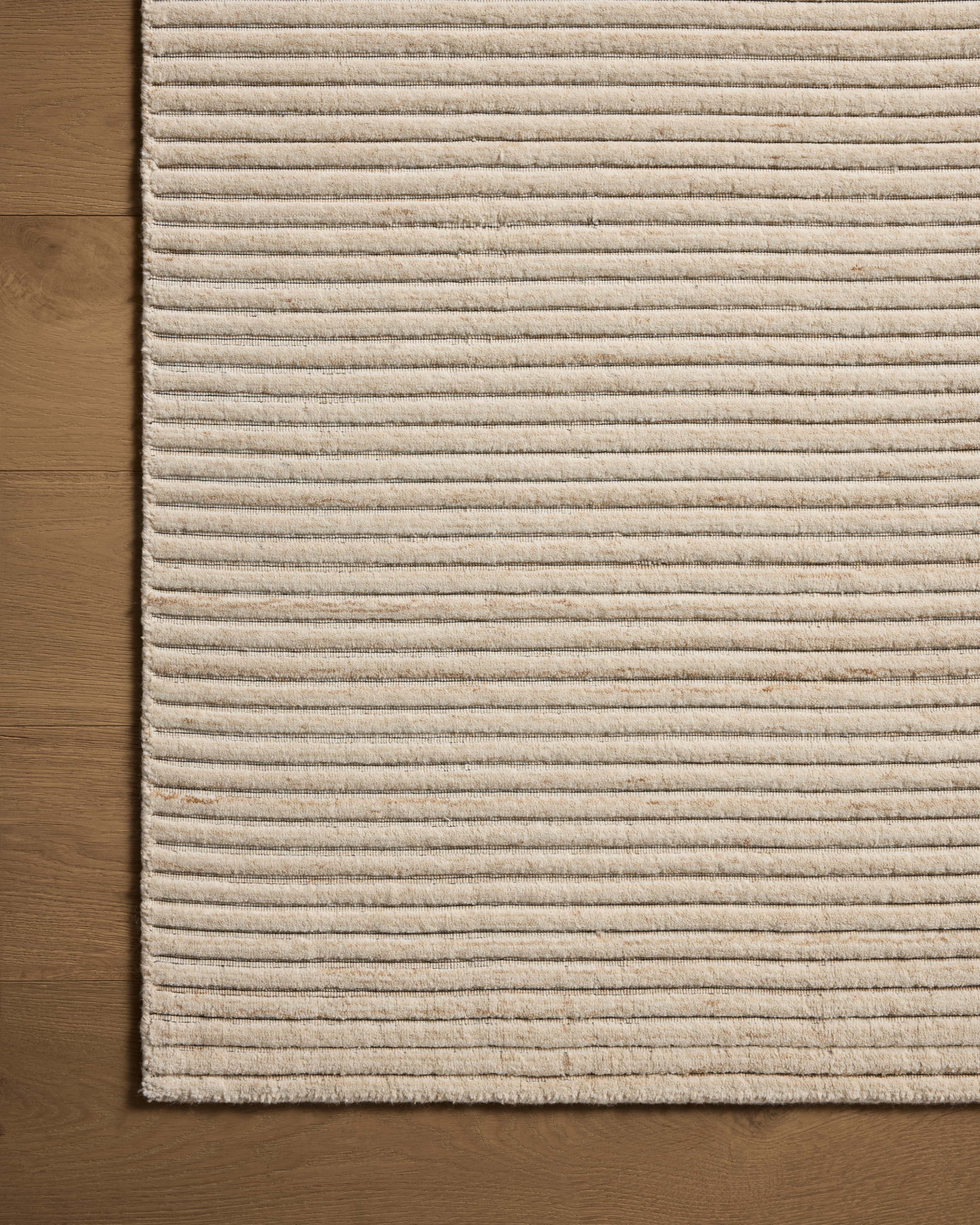 The Sterling STL-01 Ivory Area Rug transforms any space with refined ivory tones in a hand-loomed polyester area rug