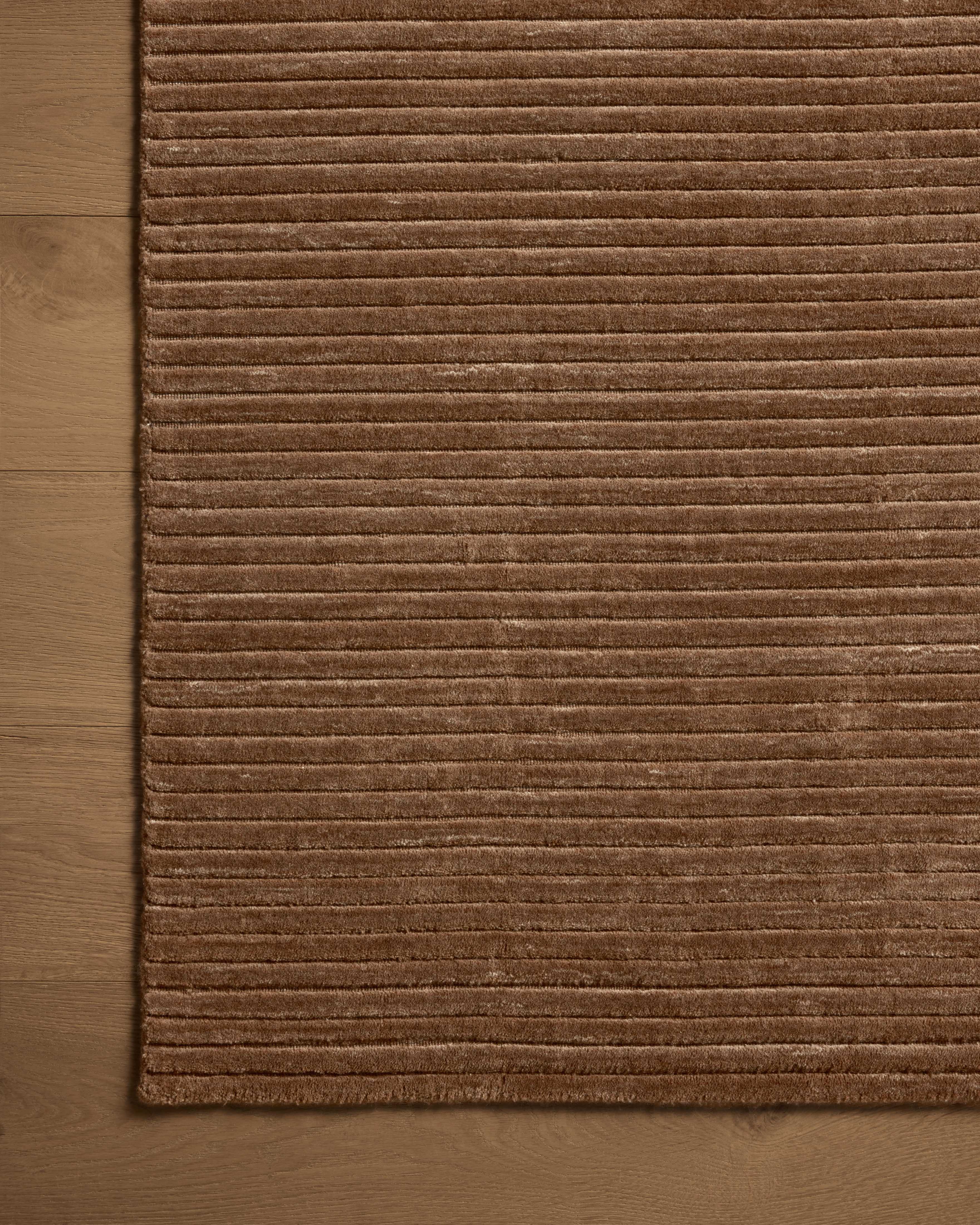 A hand-loomed polyester area rug in luxurious mocha tones, the Sterling STL-01 Mocha Area Rug grounds your room beautifully