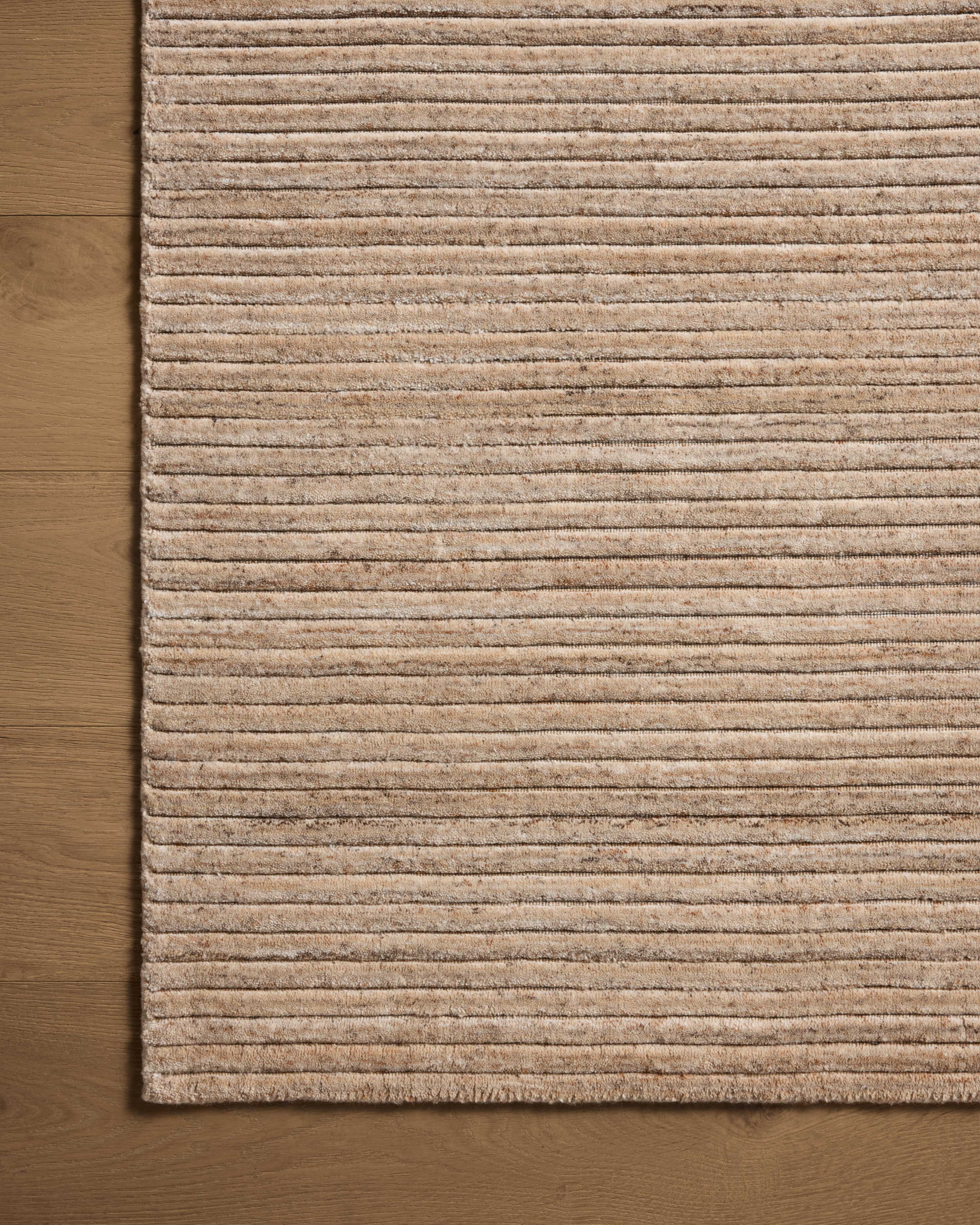 The Sterling STL-01 Natural Area Rug is a hand-loomed polyester area rug that radiates warm natural charm