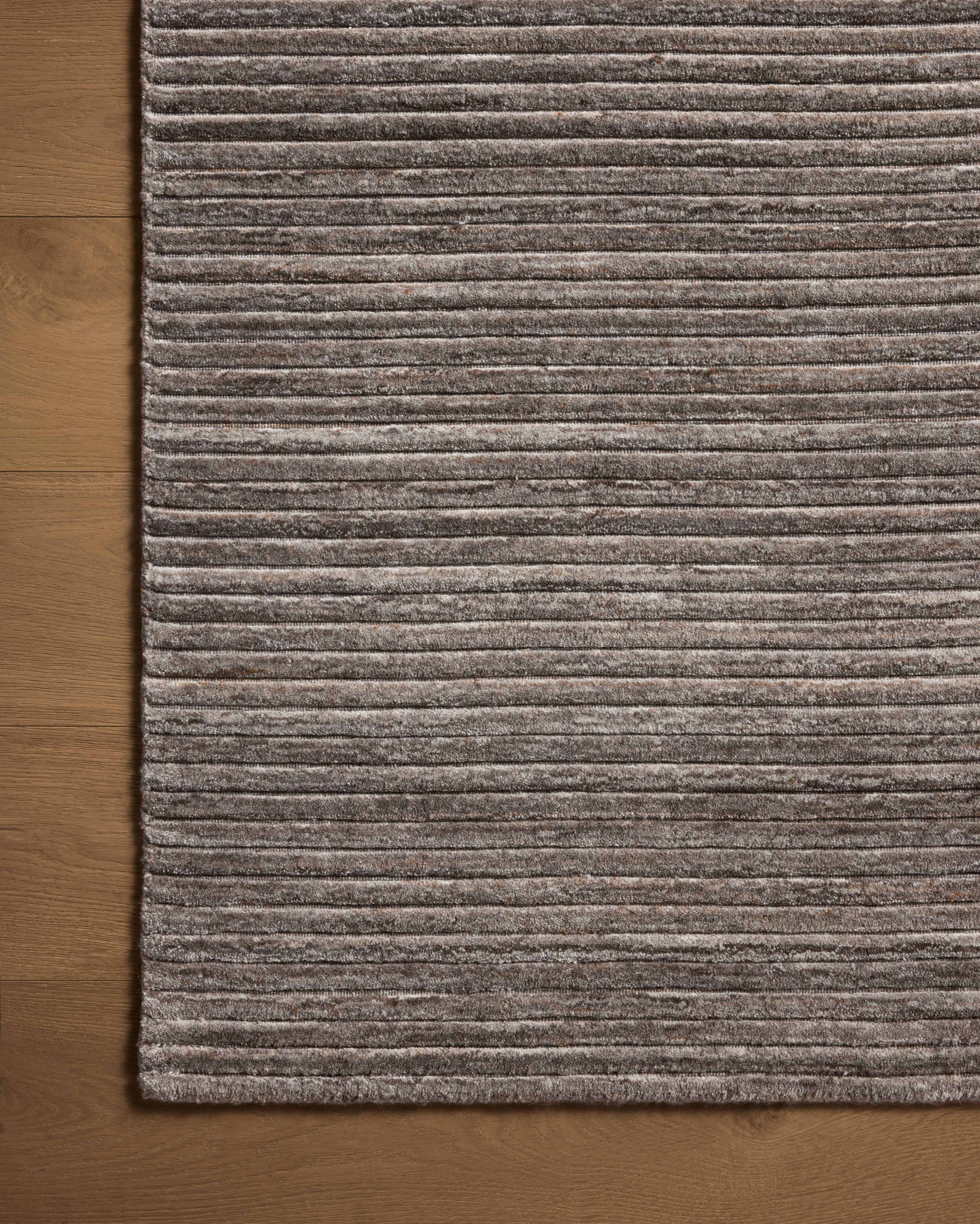 Layered in grounding stone hues, the Sterling STL-01 Stone Area Rug is a hand-loomed polyester area rug perfect for any setting