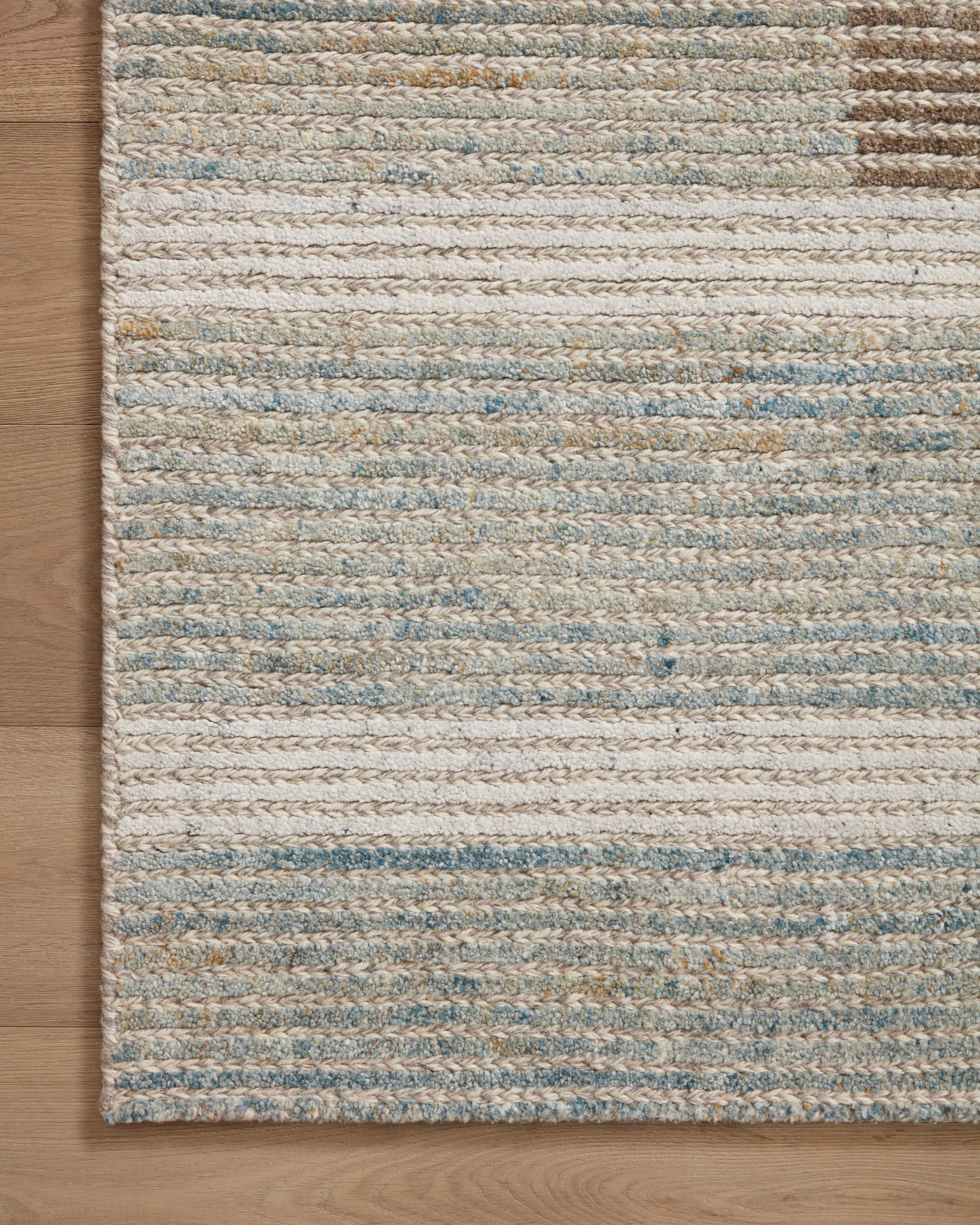 Layered in rich tobacco and tranquil lagoon hues with colorblock and ribbed patterns, the Stiles STI-02 Tobacco / Lagoon Area Rug is a hand-tufted 100% wool area rug perfect for any setting