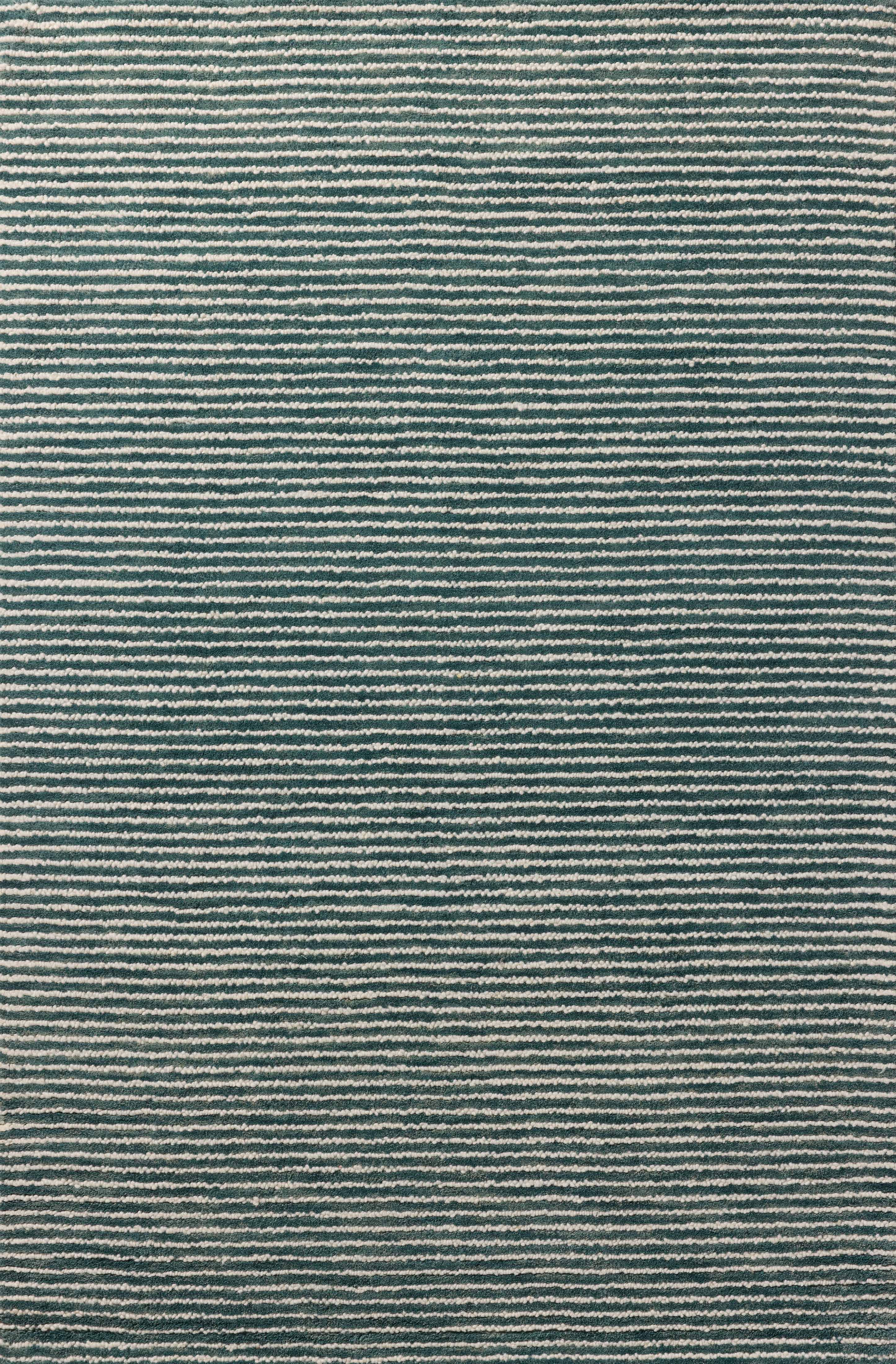 The Sunday SUN-01 Ocean / Ivory Area Rug blends serene ocean and refined ivory tones into a hand-tufted wool area rug with timeless appeal
