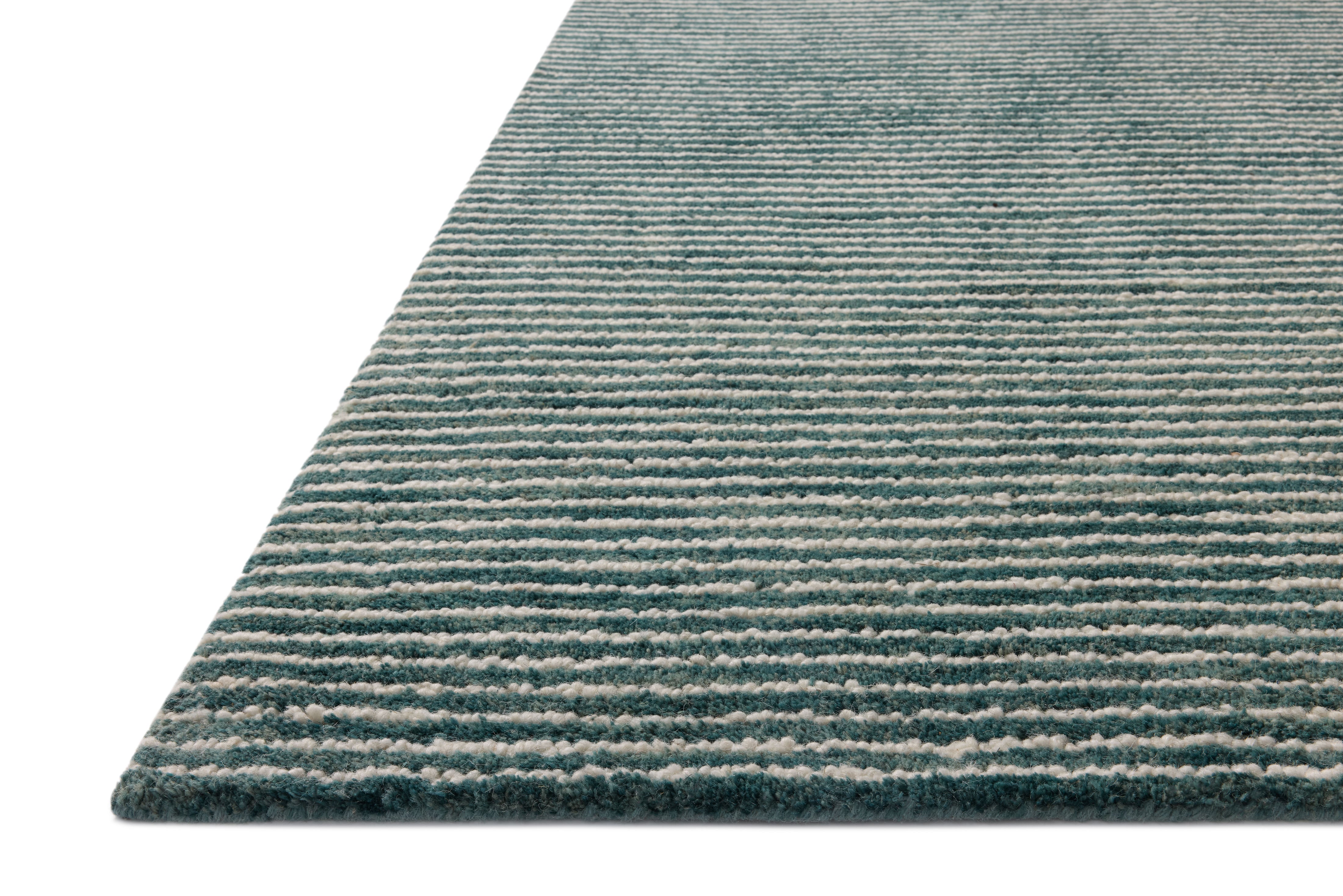 The Sunday SUN-01 Ocean / Ivory Area Rug blends serene ocean and refined ivory tones into a hand-tufted wool area rug with timeless appeal