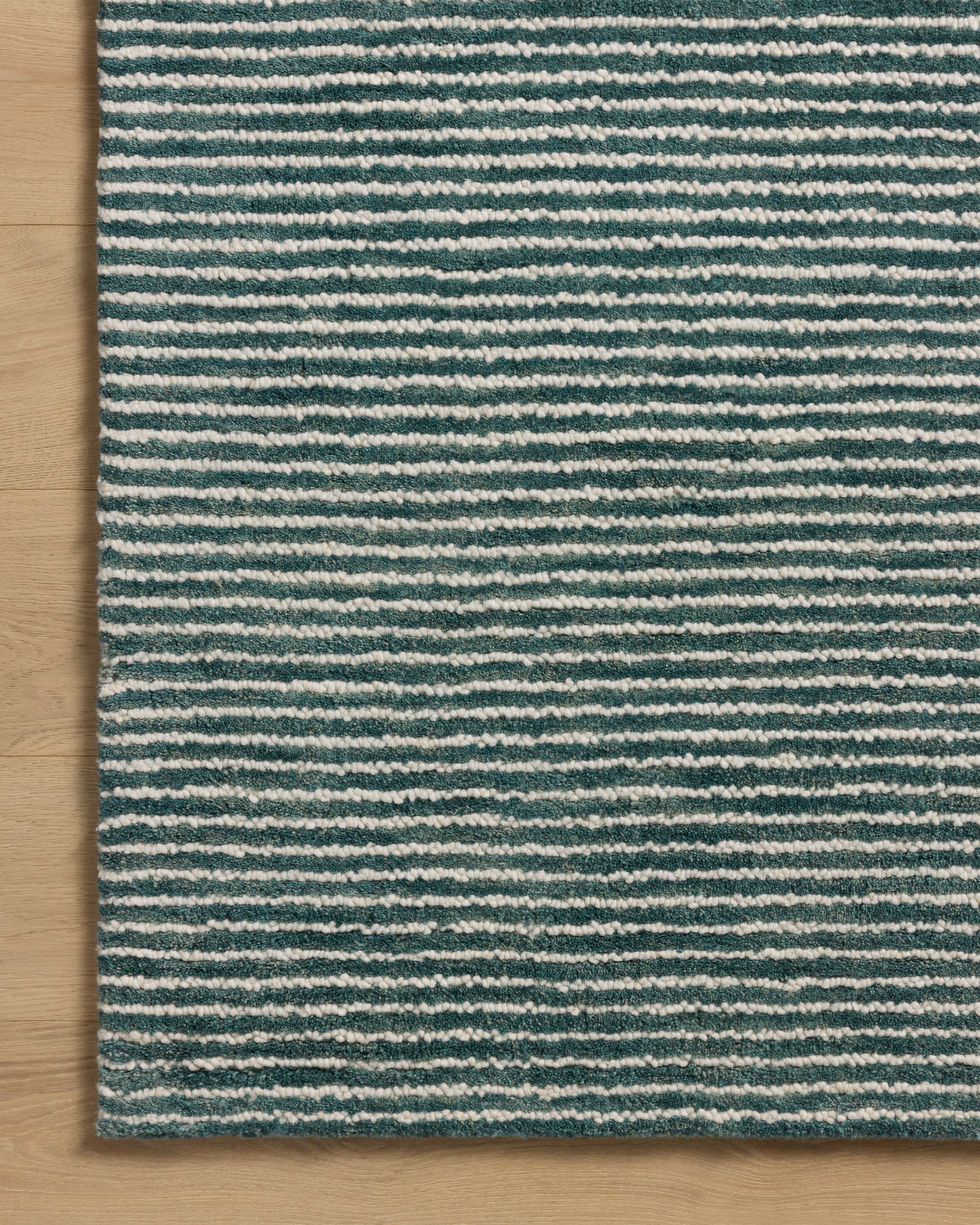 The Sunday SUN-01 Ocean / Ivory Area Rug blends serene ocean and refined ivory tones into a hand-tufted wool area rug with timeless appeal