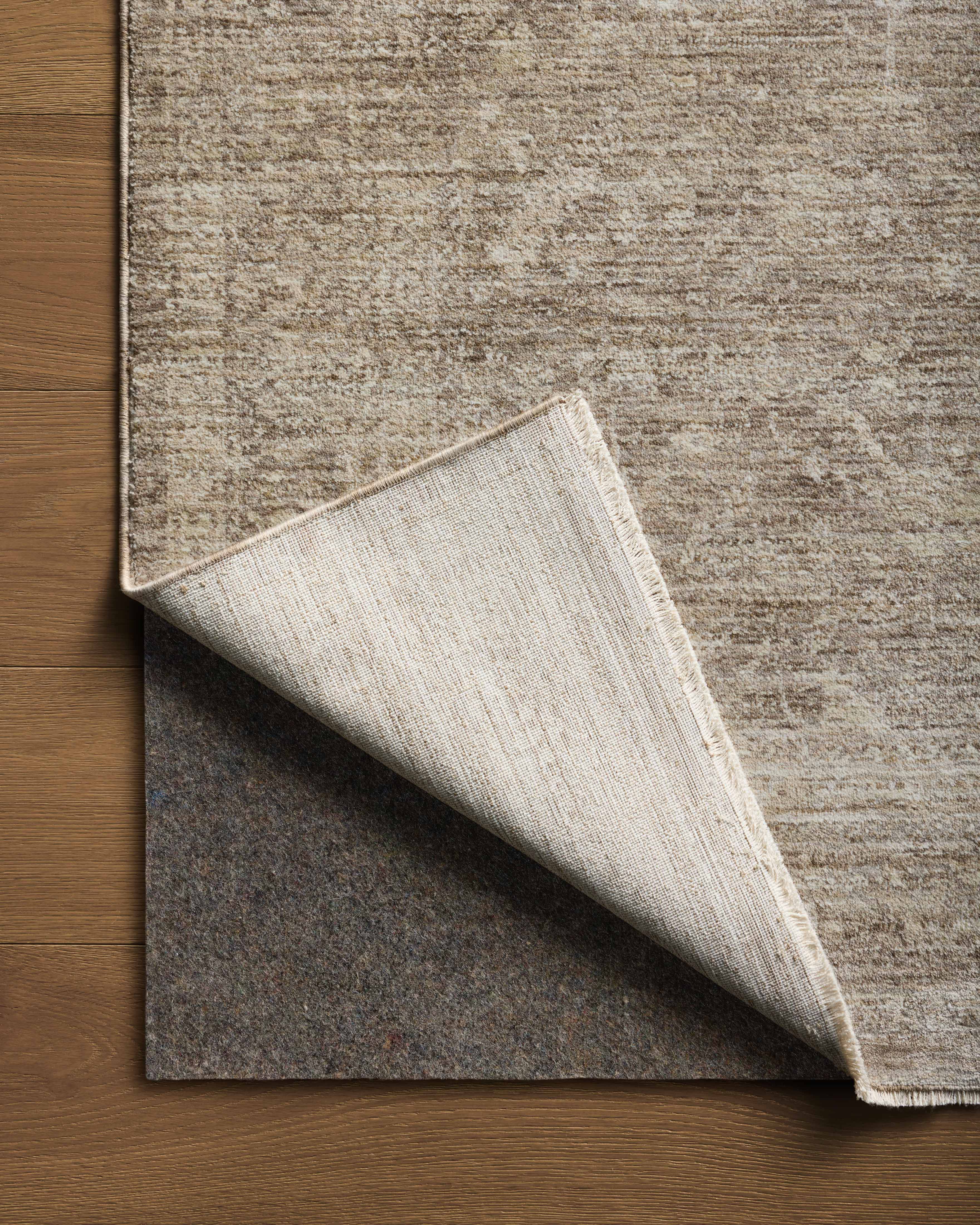 Crafted as a power-loomed polyester area rug, the Tabitha TAI-02 Taupe / Pebble Area Rug brings versatile taupe and subtle pebble warmth and traditional character to your space