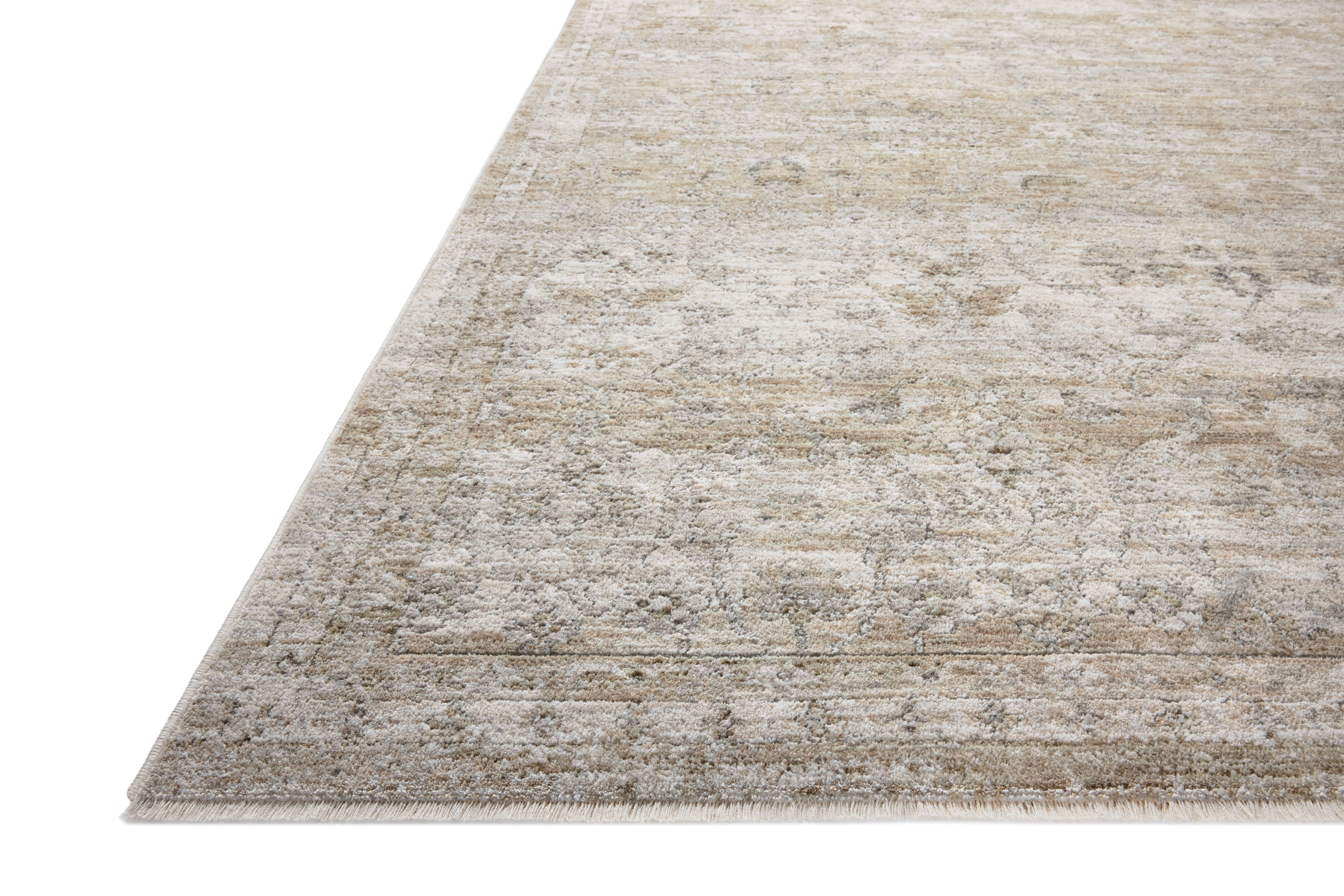 With refined ivory and khaki hues and traditional styling, the Tabitha TAI-03 Ivory / Khaki Area Rug is a power-loomed polyester area rug that elevates any room